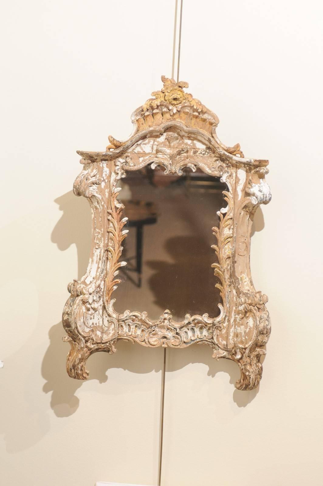 Small 18th century carved wood Venetian mirror.

I suspect that at one time, this mirror had a gilded finish over gesso. What we have now is a very interesting finish with mostly wood showing but with the remains of the gilt and gesso adding