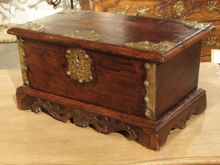 This small 18th century wooden document trunk with brass mounts would have been owned by a Dutch sailor or government official. The trunk is associated with the V.O.C. of the Dutch Golden Age, likely putting production in the early