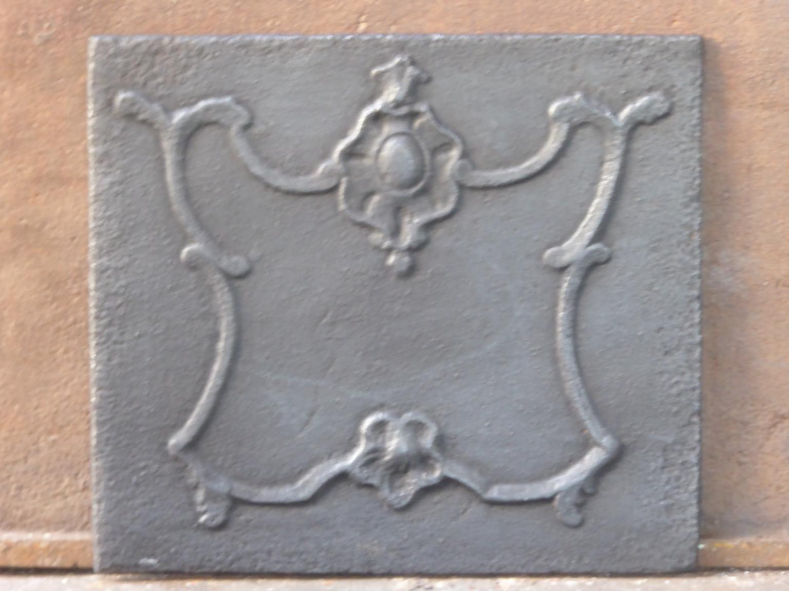 Small 18th century French Louis XV fireback with a typical Louis XV decoration. The fireback is made of cast iron and has a black / pewter color. The fireback is in a good condition and has no cracks.








   