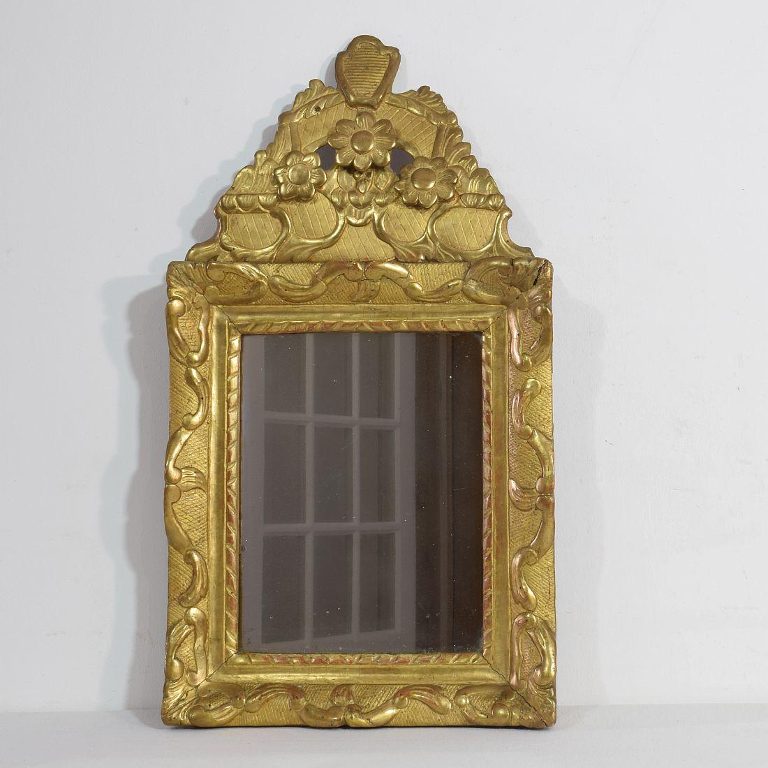 Small Louis XV giltwood mirror with beautiful original weathered mirror glass
France, circa 1750. Weathered., small losses and old repairs.
