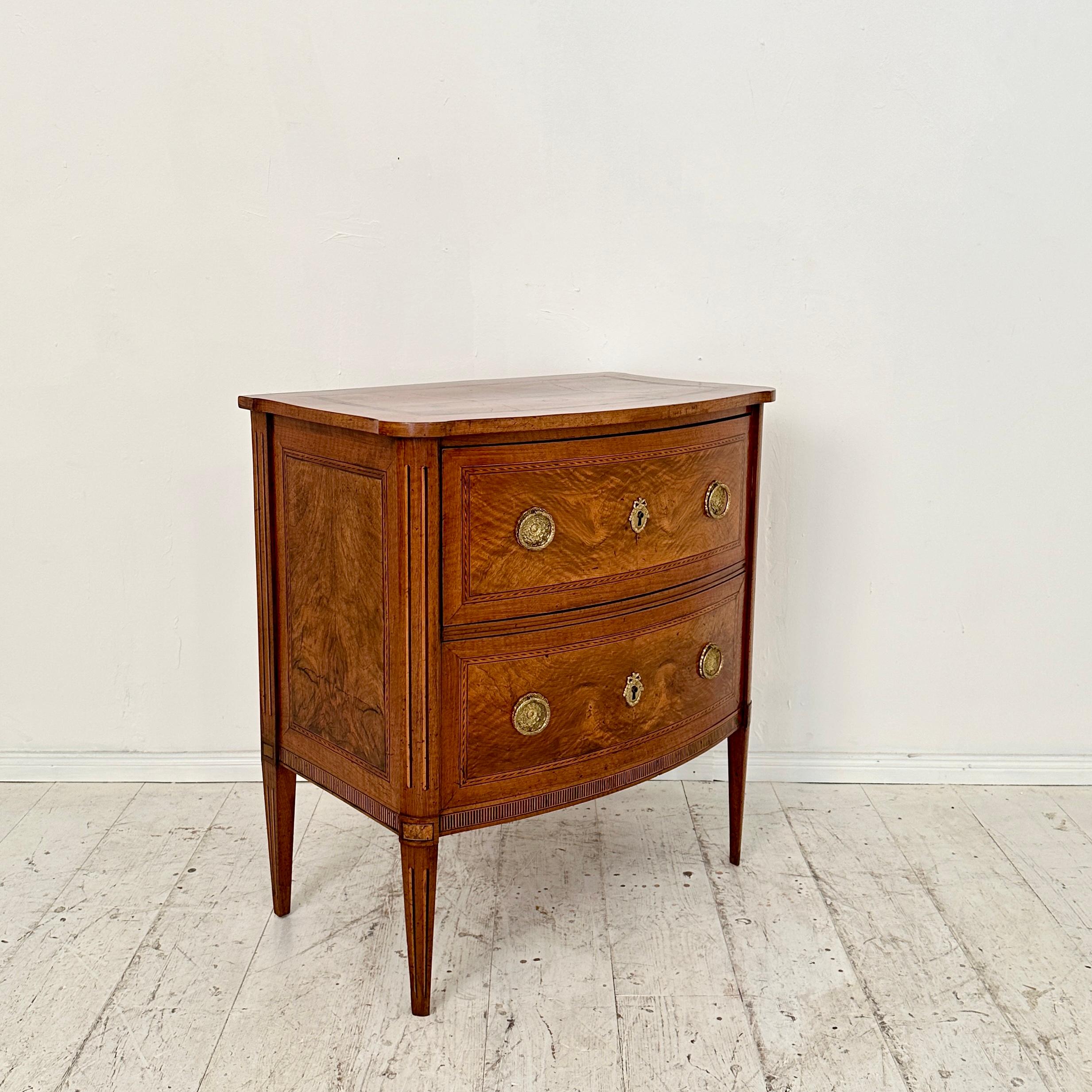 Crafted in the opulent style of Louis Seize during the late 18th century, this Small German Commode in Walnut with Two Drawers stands as a refined testament to the elegance of the era. Made from walnut veneer, it exudes a timeless charm, showcasing