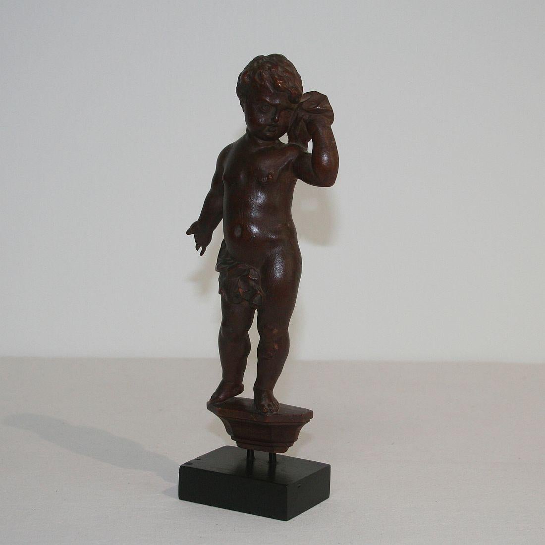 Beautiful small angel figure, Italy, circa 1750. Weathered, small losses. Measurements with the base.