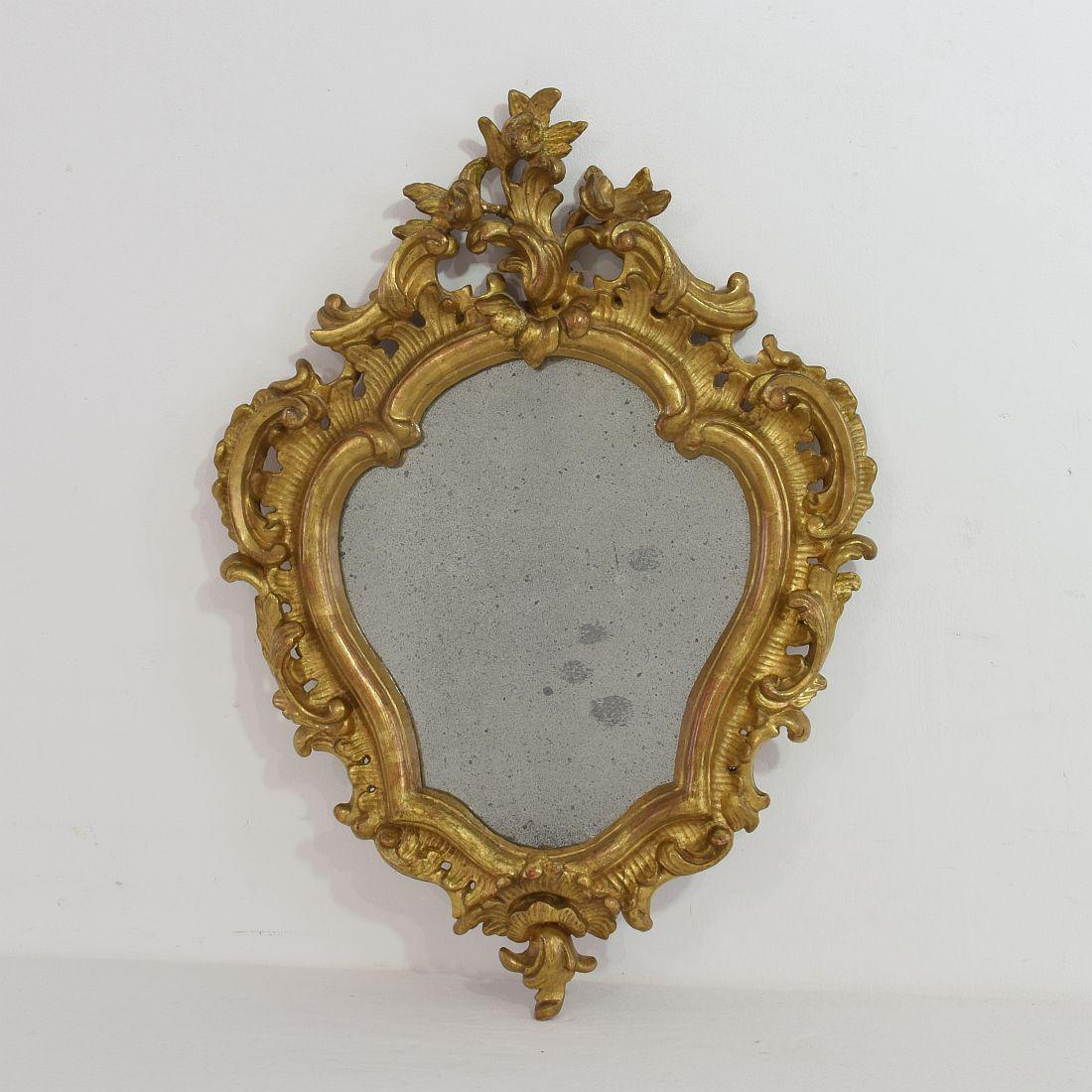 Well carved small giltwood Baroque mirror. Gorgeous small piece, Italy, 18th century. Weathered and old repair.



   
