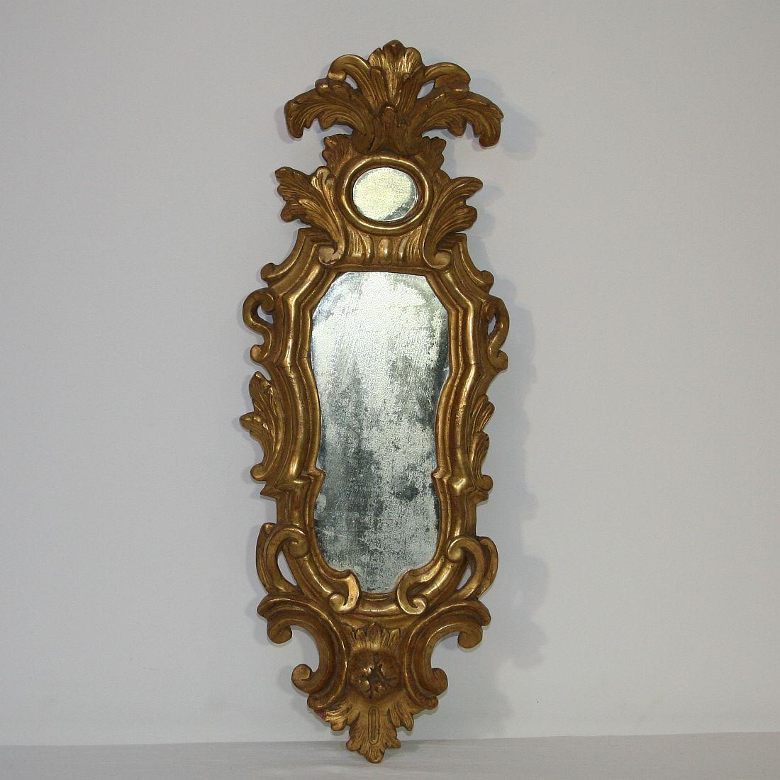 Stunning small baroque giltwood mirror, Italy, circa 1750.
Weathered, small losses and old repairs. Traces of inactive woodworm.


 