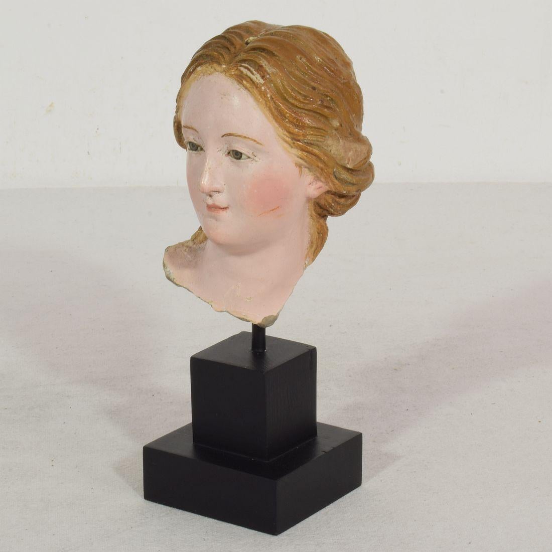 Stunning handcrafted terracotta head fragment of a Madonna with beautiful expression and glass eyes,
Italy, circa 1750-1800. Beautiful example of 18th century craftsmanship.
Weathered and small losses.
Measurement here below is inclusive the
