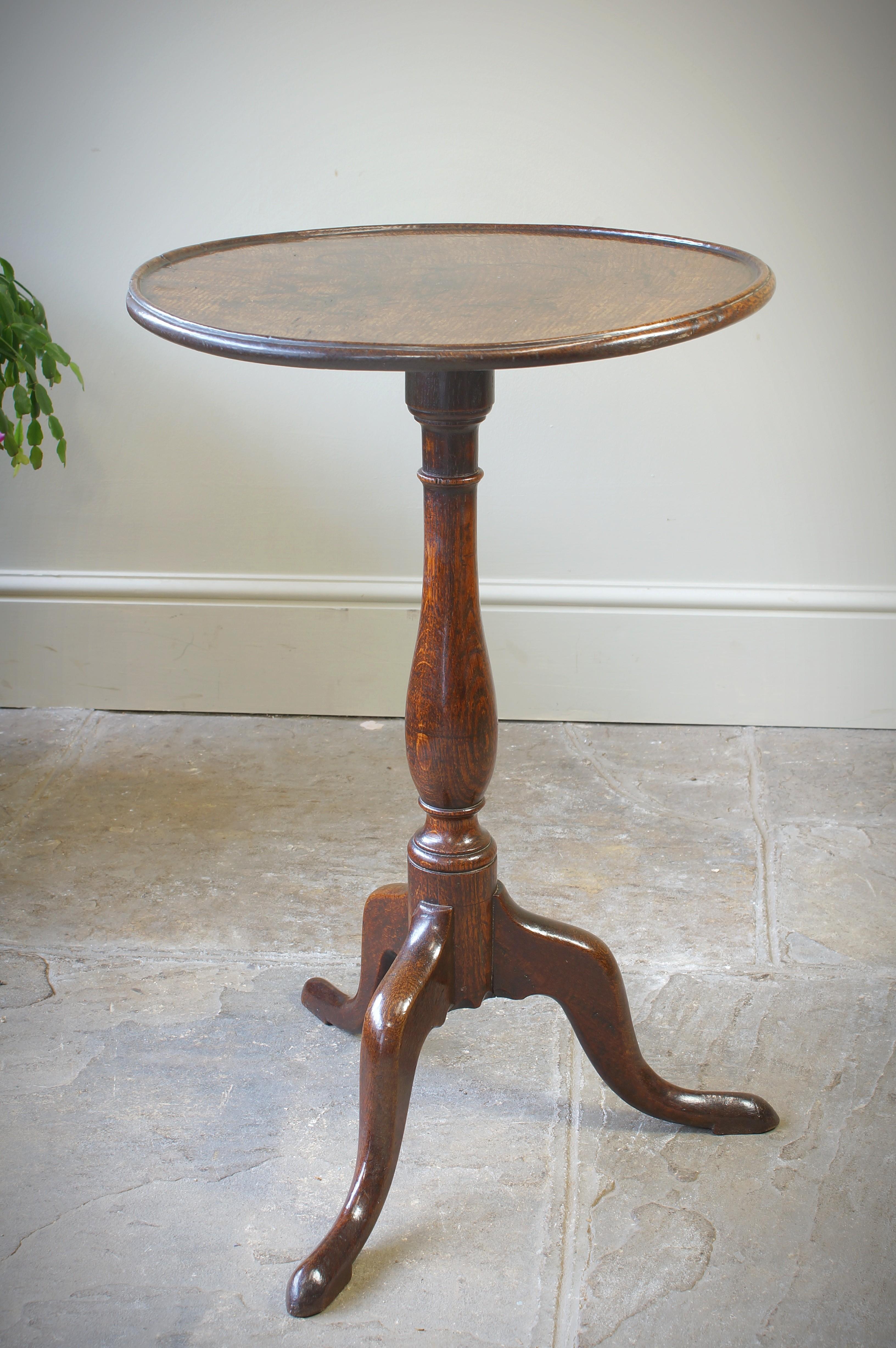 An excellent 18th Century oak wine/ tripod table with a one piece dished top supported on an elegant turned column terminating with three shaped legs. Circa 1780.
Excellent colour and condition. Slight damage to the underside of the edge, please see