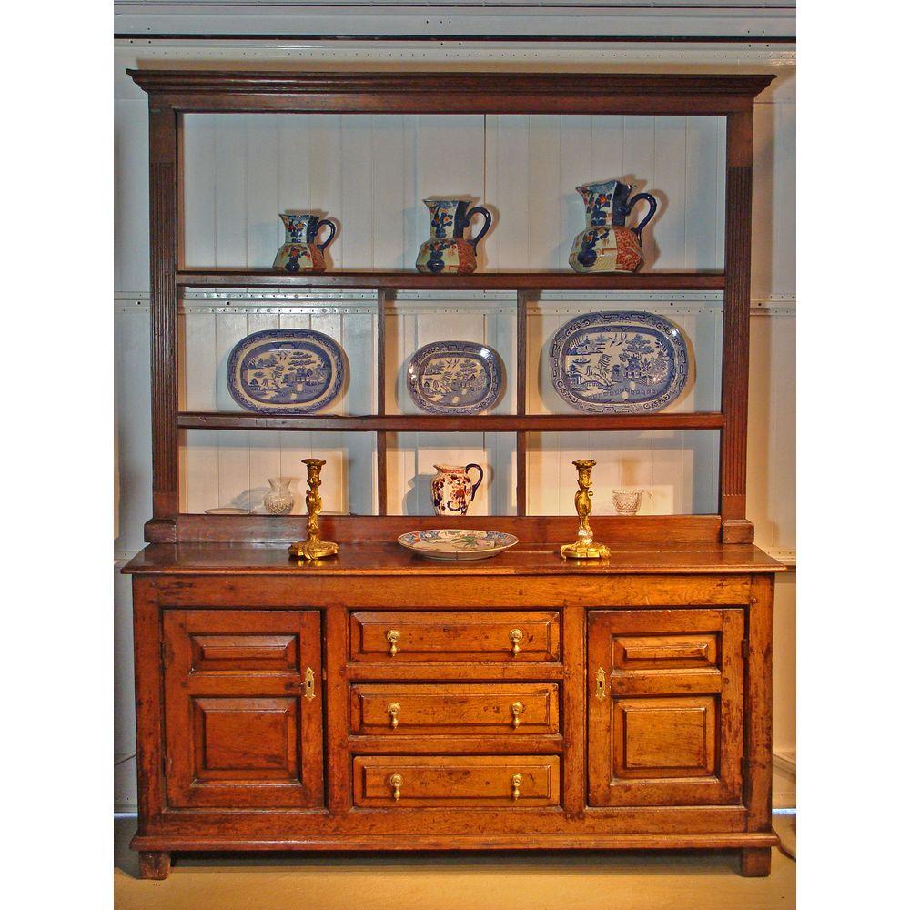A small early-18th century Welsh oak sideboard, of good rich color and patination.
With three fielded, panelled and chamfered central working drawers, flanked by double fielded panelled doors.

Attractive and versatile for use in a hallway, for