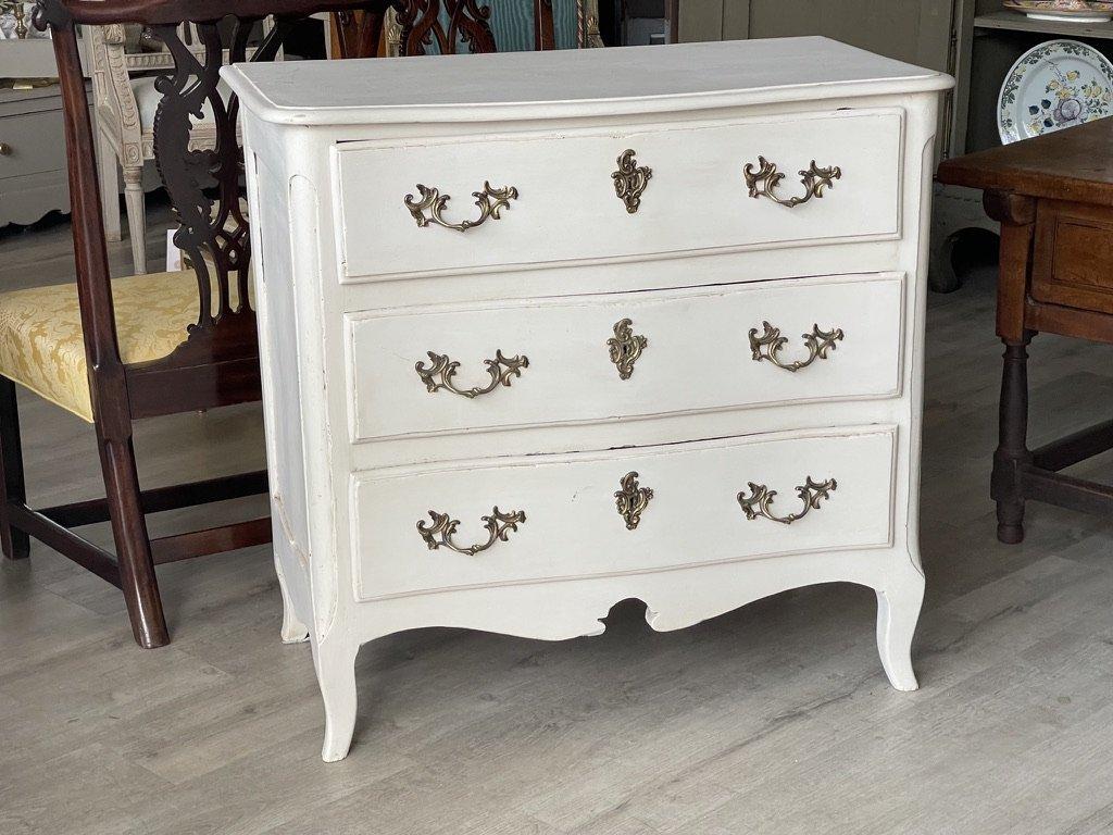 Diminutive 18th century French walnut commode chest of drawers with a white painted finish, A serpentine example with short cabriole legs, three dovetailed drawers with original Rococo hardware, all below the conforming molded top. The painted