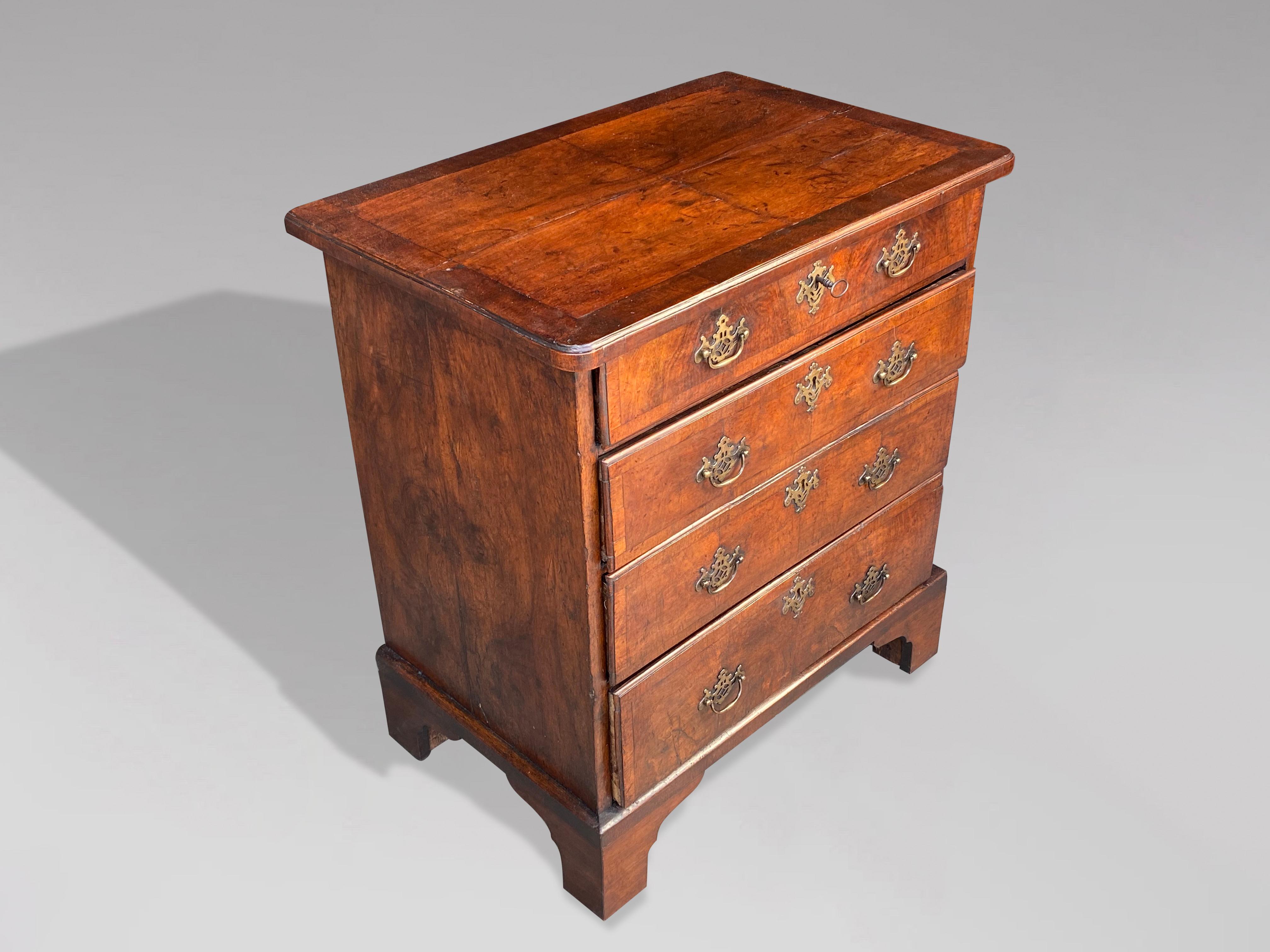 A fine late 18th century, George III period walnut and oak lined chest of drawers of smaller proportions and of great colour & patina. A rectangular veneered walnut top with moulded edge above four long graduated oak lined drawers standing on