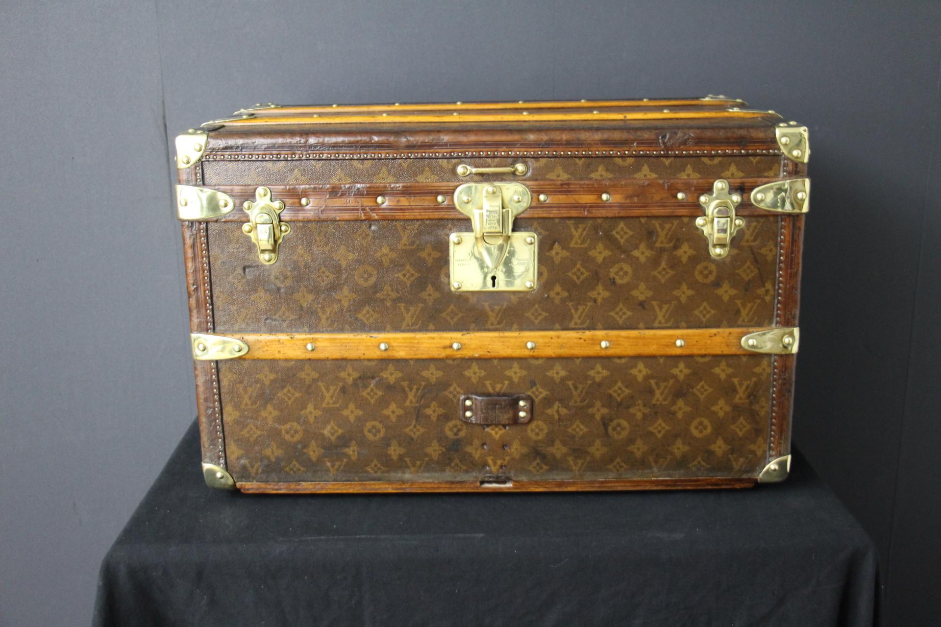This lovely little Louis Vuitton steamer trunk features stenciled monogram, all chocolate color leather trim, solid brass corners, locks, and side handles. Its brass locks, studs and side handles are all marked Louis Vuitton.
It has got a very warm
