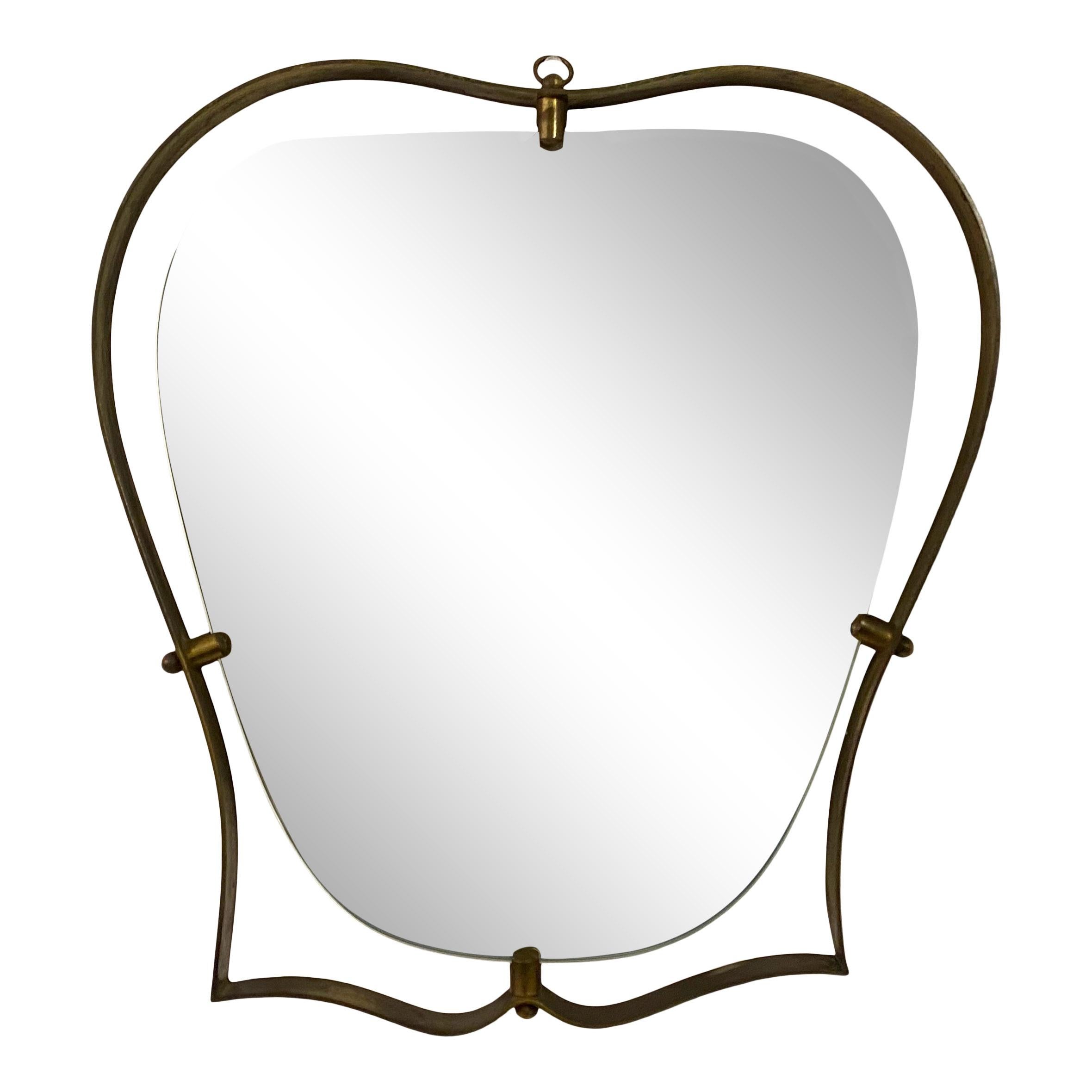 Shaped mirror

Brass frame

Brass mirror supports

Probably not original glass plate

Italy 1950s.
 