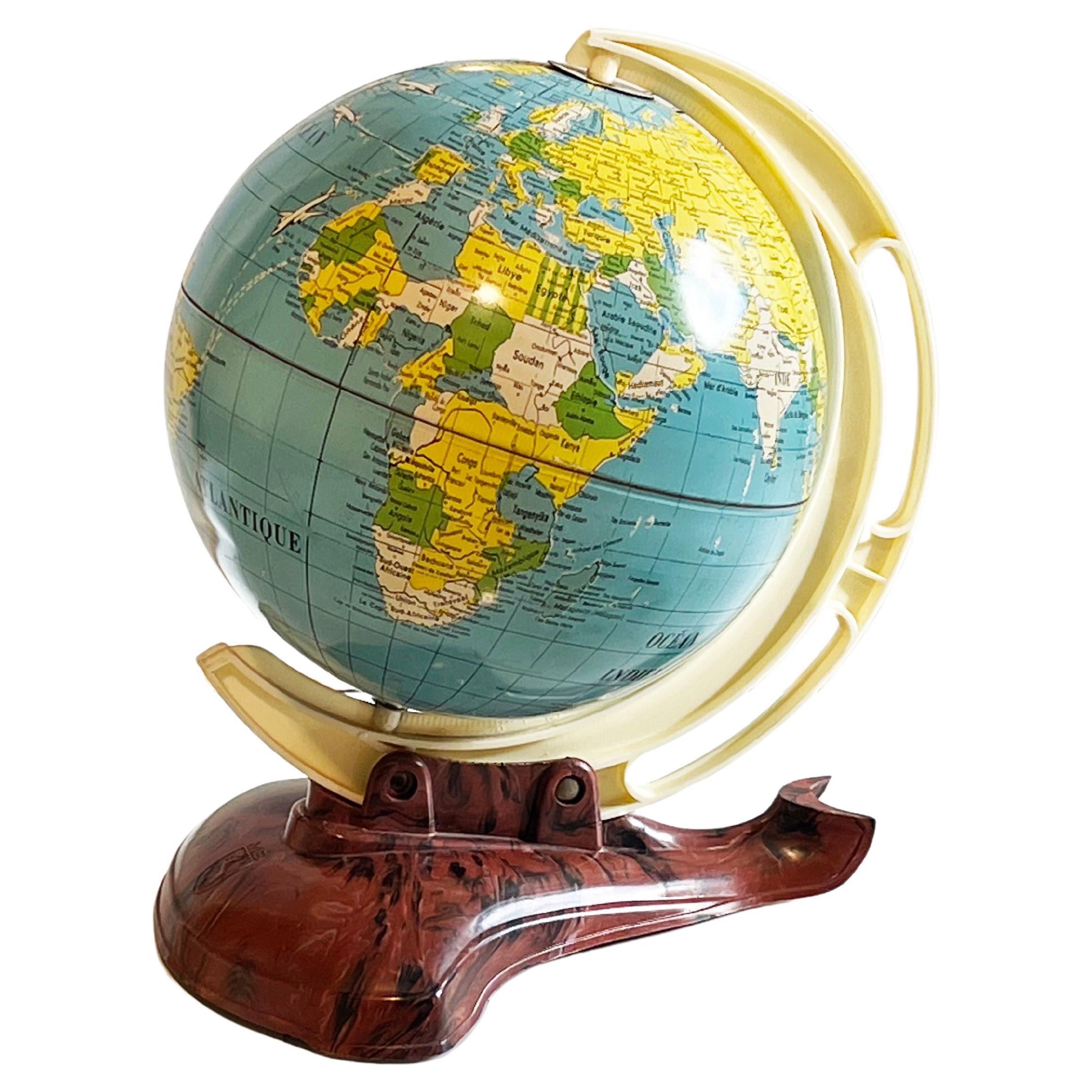 Wonderful find, labeled in French and made for Belgium:
by MS (Michael Seidel, Western Germany). This tin globe was made around 1951 and lithography / screen printed.
Classic tin toy from the mid-20th century in wonderful vintage