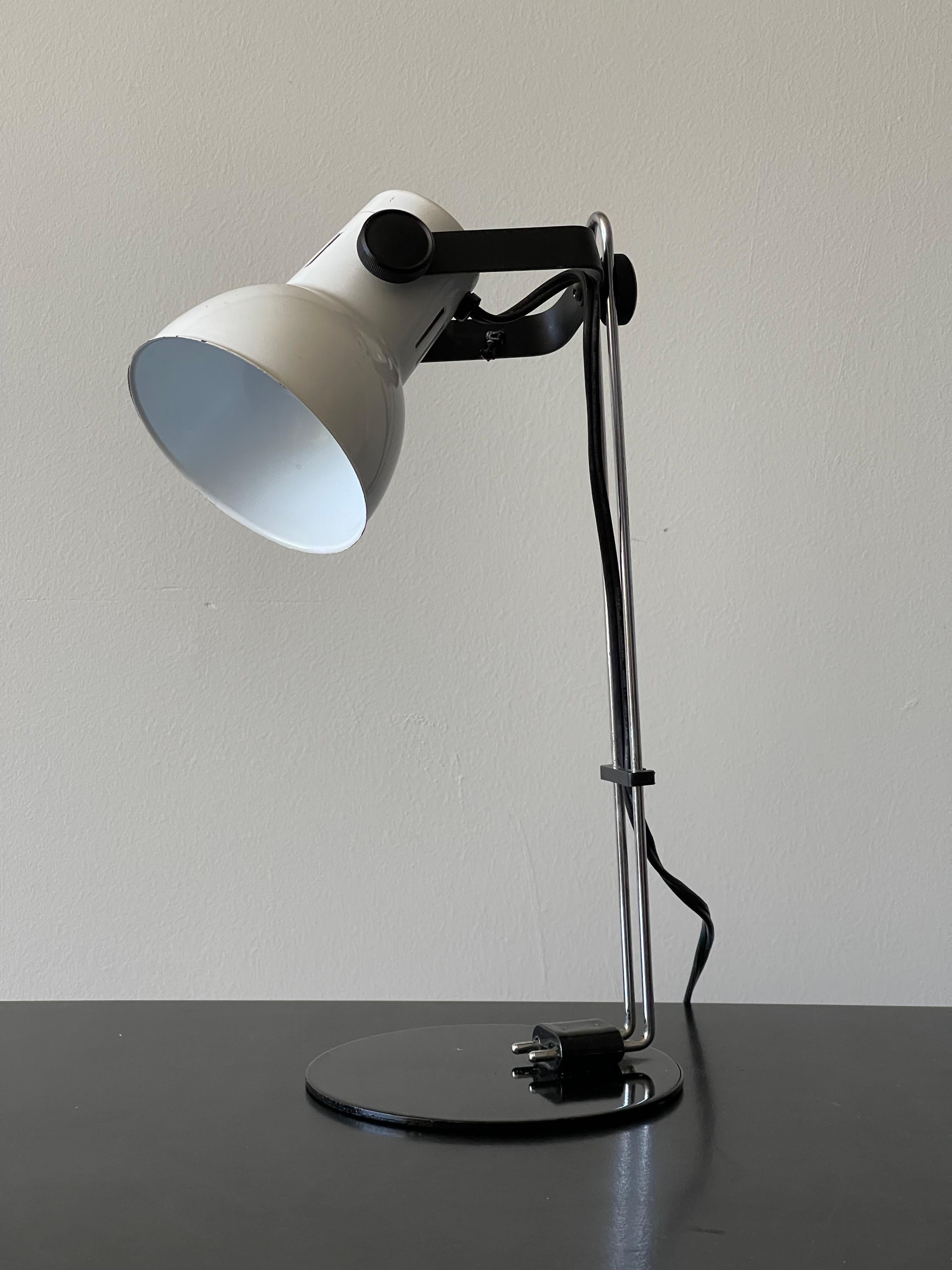 Architectural small desk lamp - articulated in every direction. The cord holder moves up and down to distribute more cord. Fun little desk lamp! 12” tall x 6.5” deep x 5” wide round metal base.