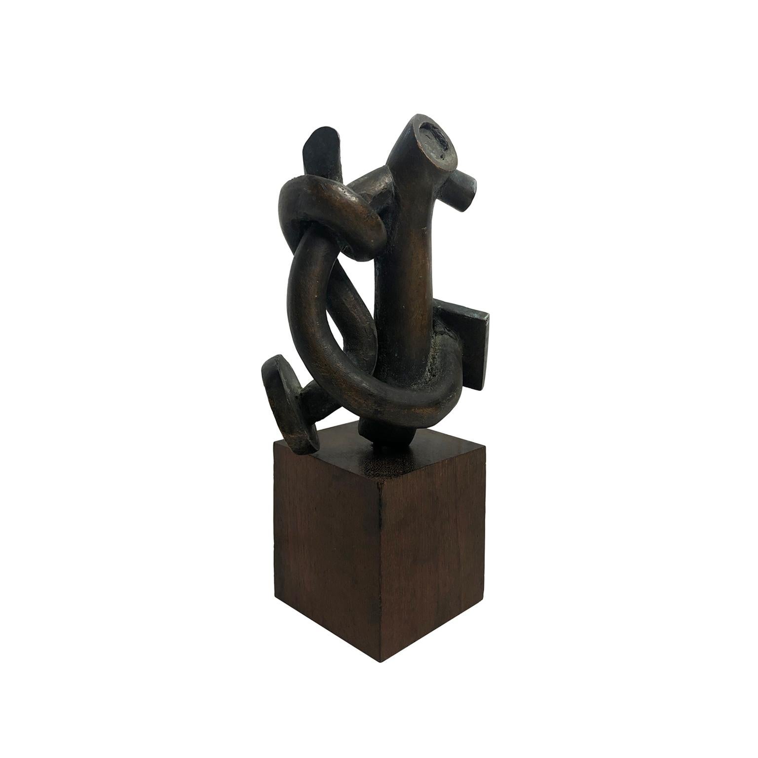 Small abstract twisted bronze sculpture on wood base. USA, 1970s.