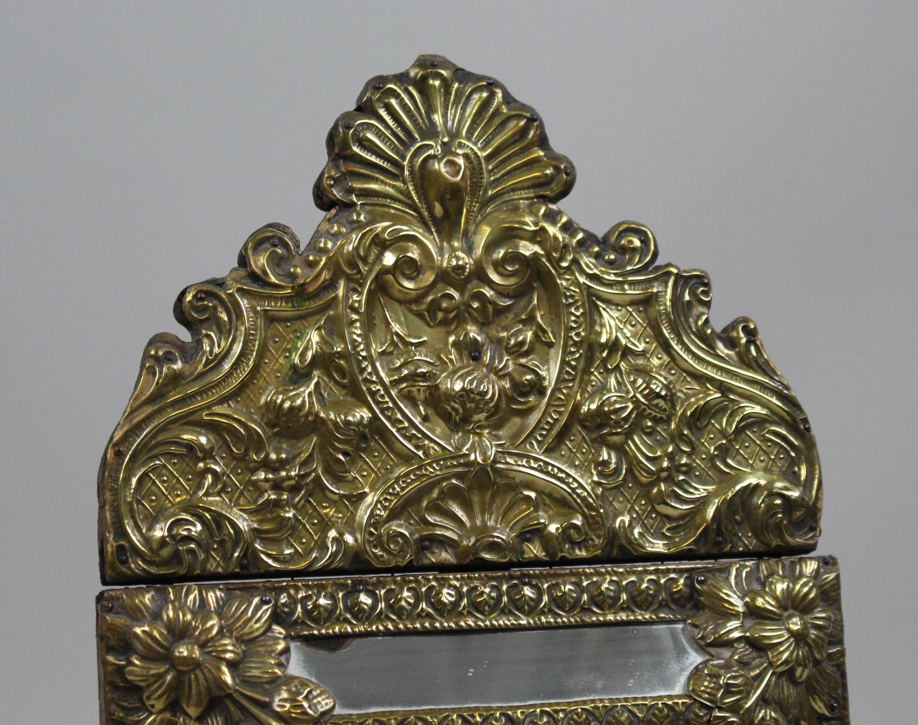 
Period 
19th century, French

Frame 
Brass, ornate repoussé work

Mirror 
Original bevelled glass

Condition 
Offered in good condition commensurate with age. Later screwed plate affixing mirror at the back. A little foxing to