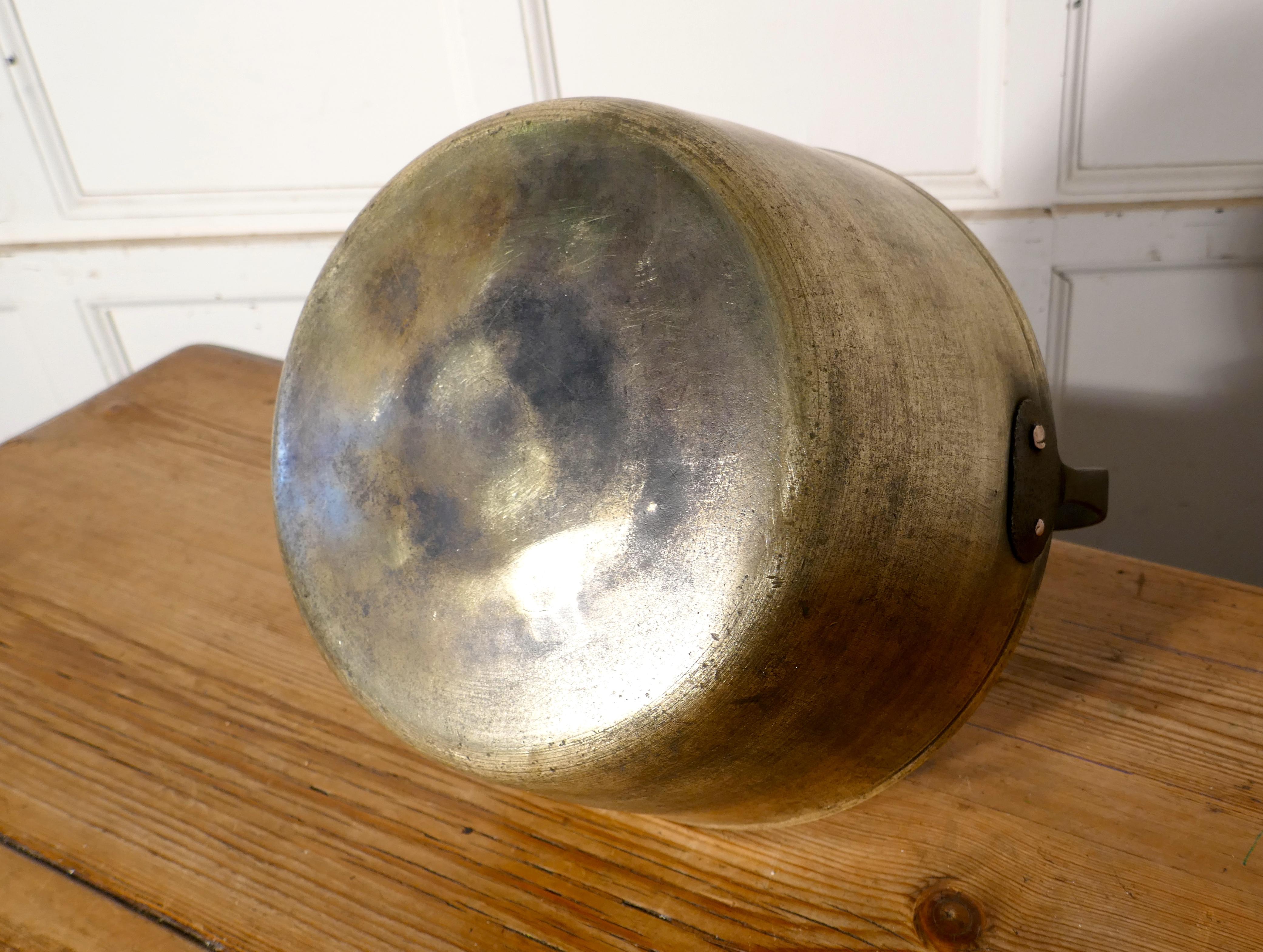 Small 19th century brass preserving pan or cooking pot

A superb piece of social history and a must for the kitchenalia, collector, this is a 19th century piece it is in sound and very usable condition, it has a riveted blacksmith made iron handle