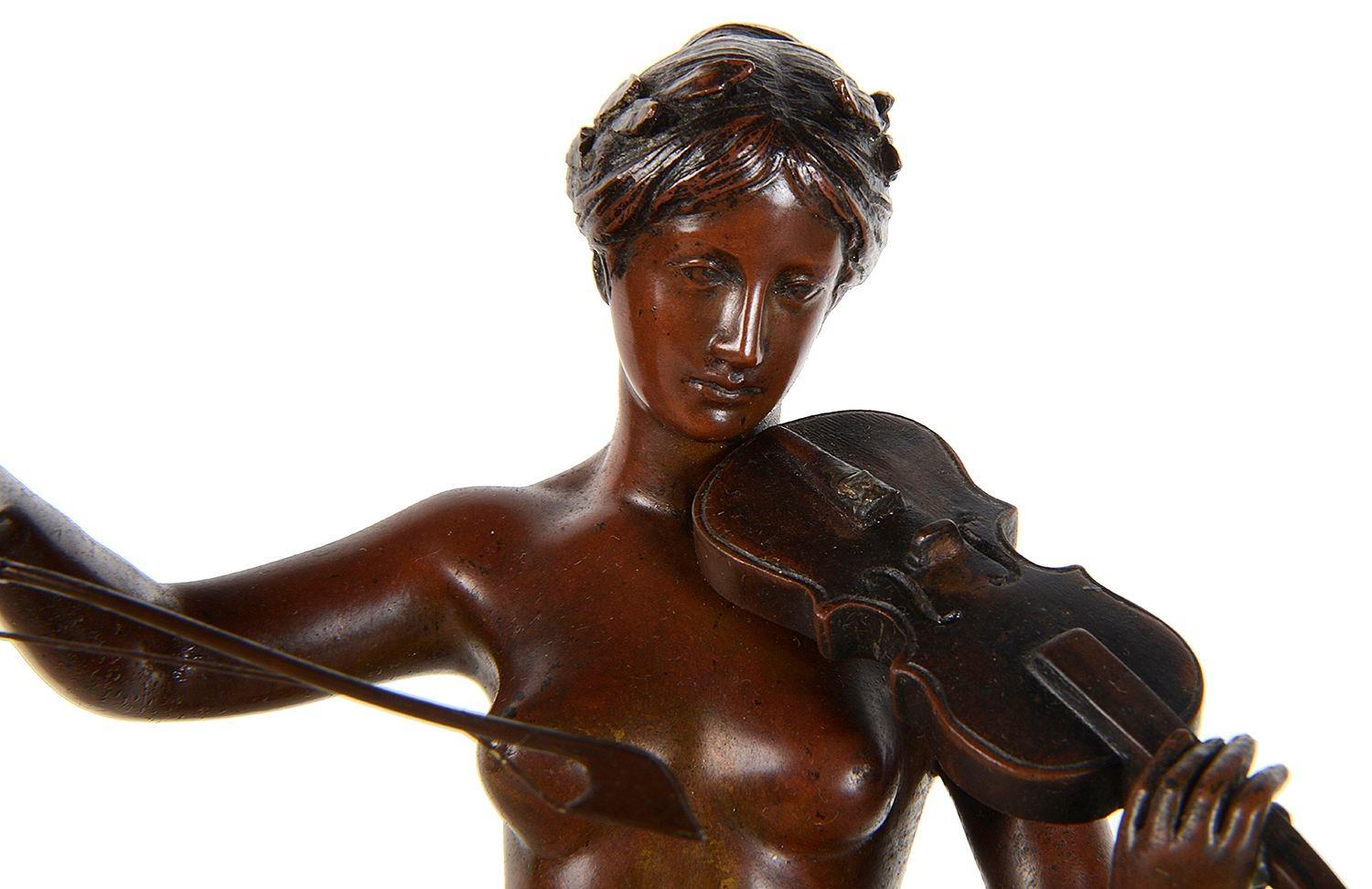 An enchanting small late 19th Century patinated bronze statue of a nude girl playing a violin, raised on a marble plinth.

Batch 81 G356/24 UNKZ