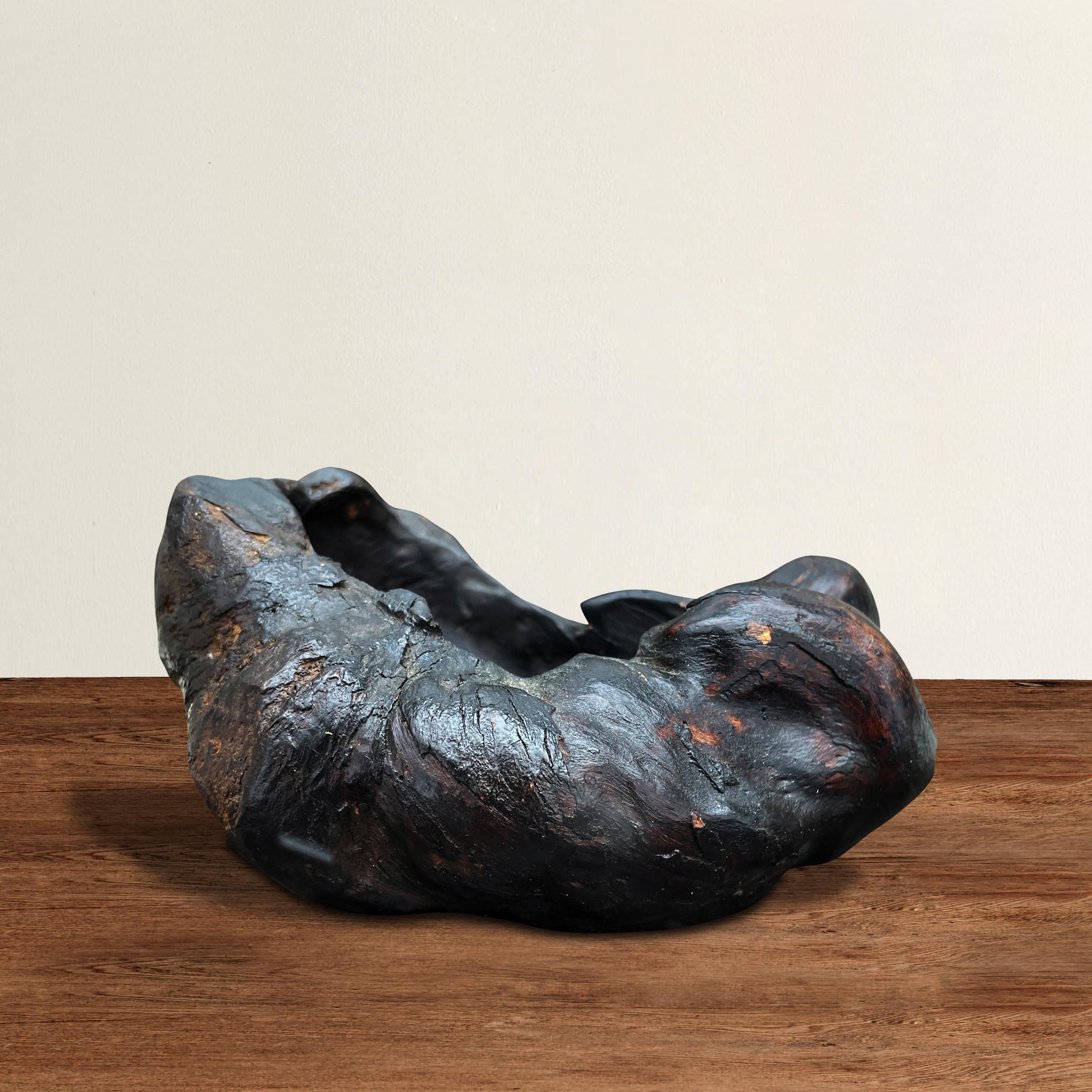 A small burl bowl, possibly Chinese, with a wild organic form and its original dark lacquer finish. Perfect for holding your key, pocket change, or to house any vices you wish.