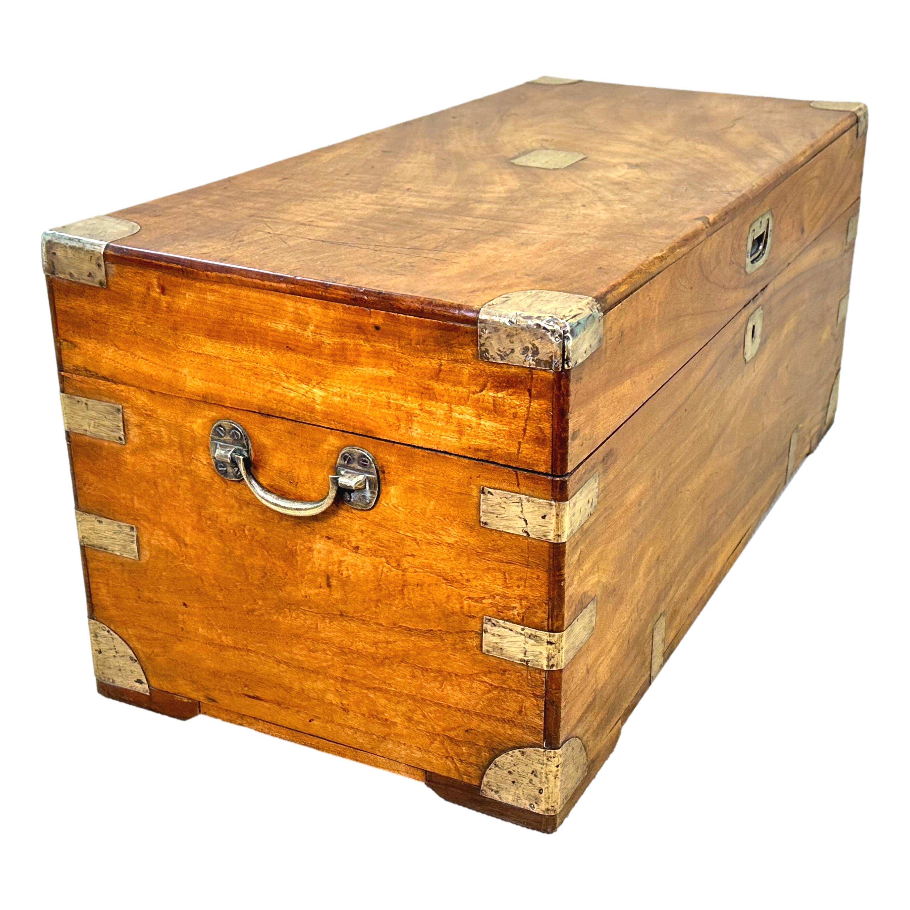 A Delightful Mid 19th Century Camphor Wood Military Campaign Trunk, Of Rare Small Proportions, Having Well Figured Lift Up Lid Enclosing Storage Space, Original Brass Bound Decoration And Original Brass Handles.


Its widely accepted that trunks