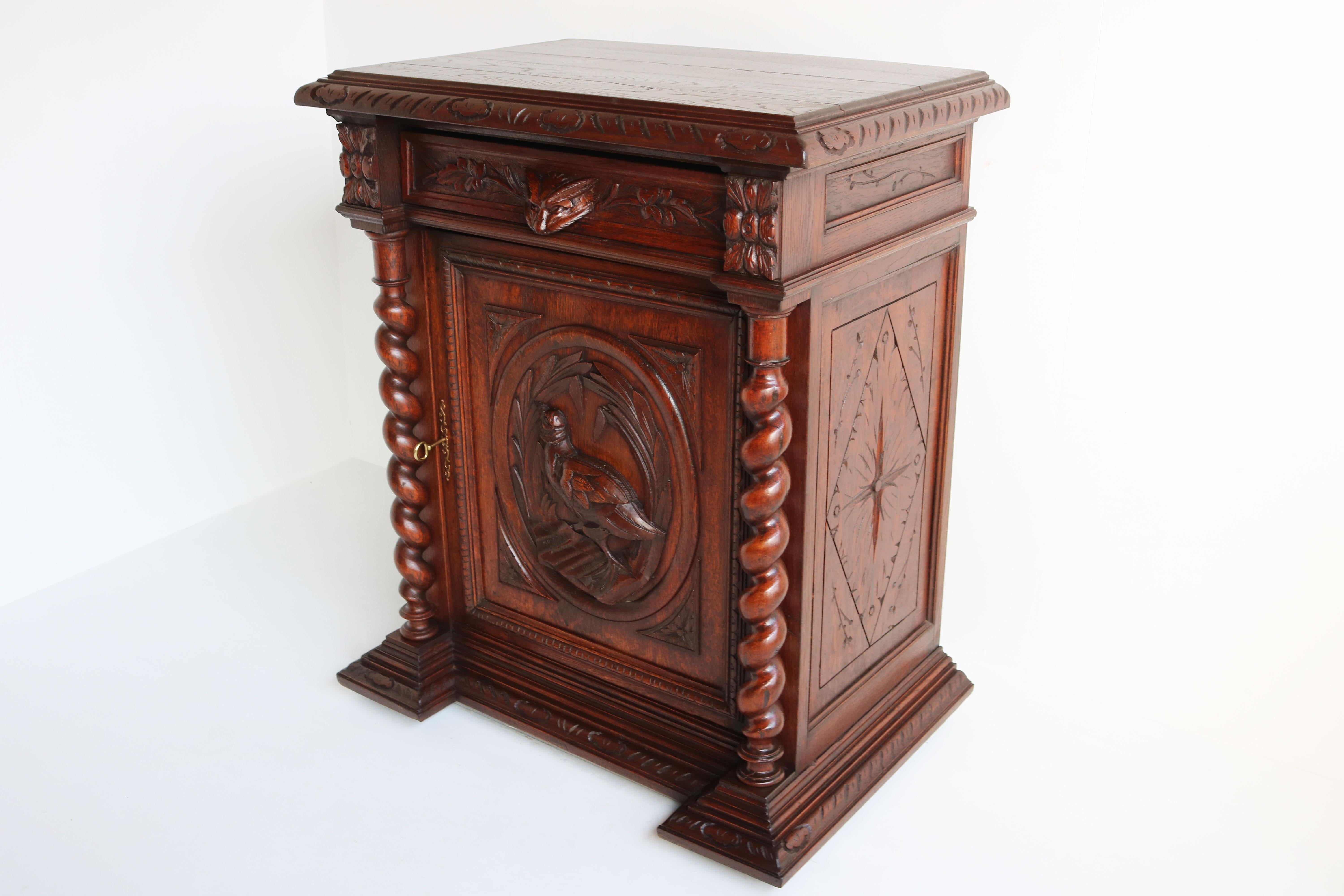 Marvelous 19th century antique French hunt / black forest style cabinet / confiturier. 
fully made from solid oak, rare model with four carved side panels. 
Carved by a master carver with much attention to detail. The handle of the drawer is a fox