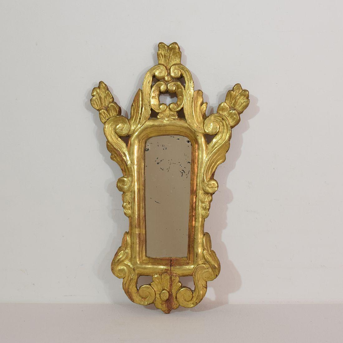 Lovely and well carved small giltwood mirror,
France, late 19th century. Weathered, small losses and old repairs.



 