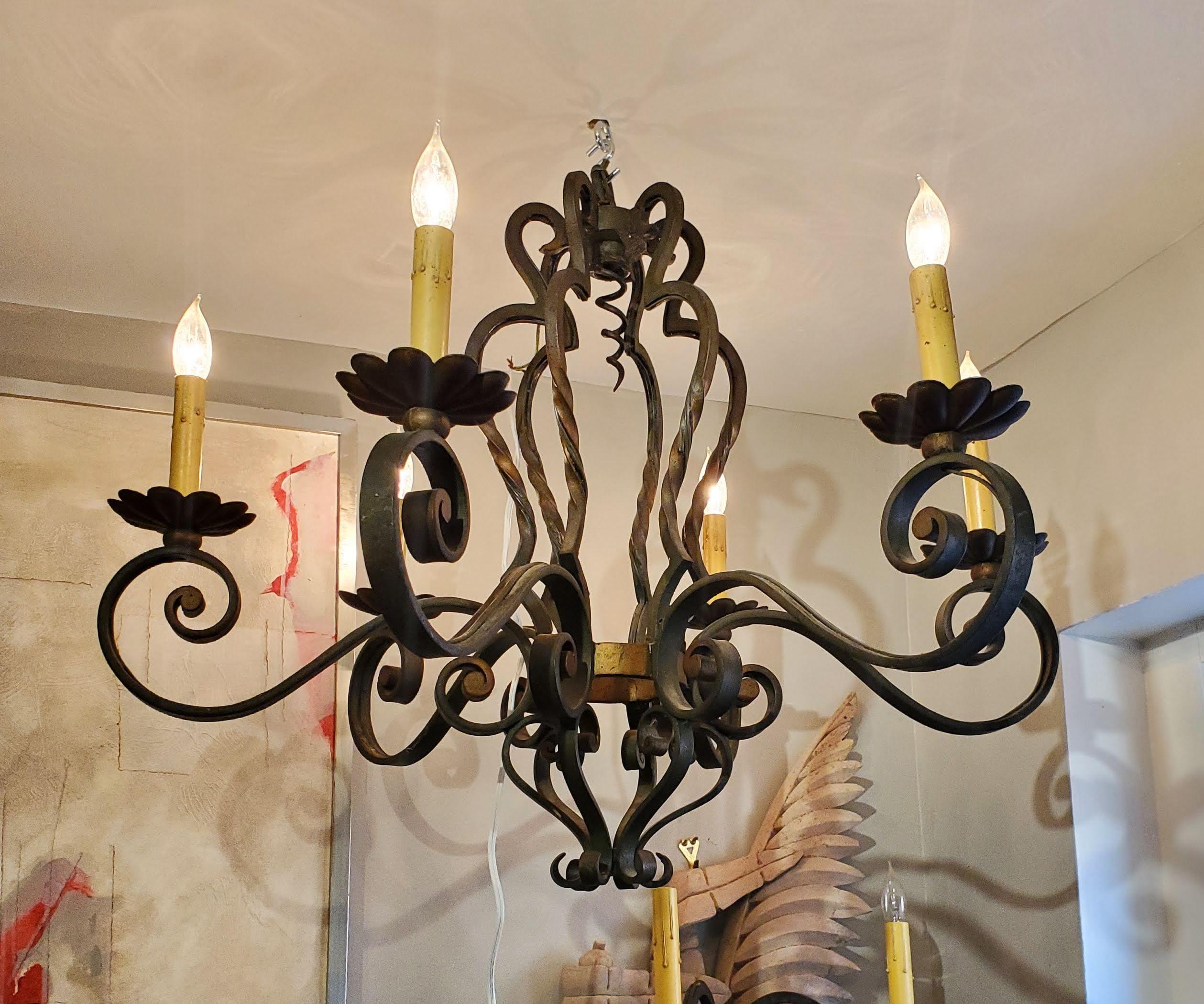 This small 19th century French provincial chandelier is perfect to hang above a kitchen table or in a hallway or entryway. Made of handcrafted wrought iron with six candle arms. Nice old patina and good proportions. Can be wired for modern use.