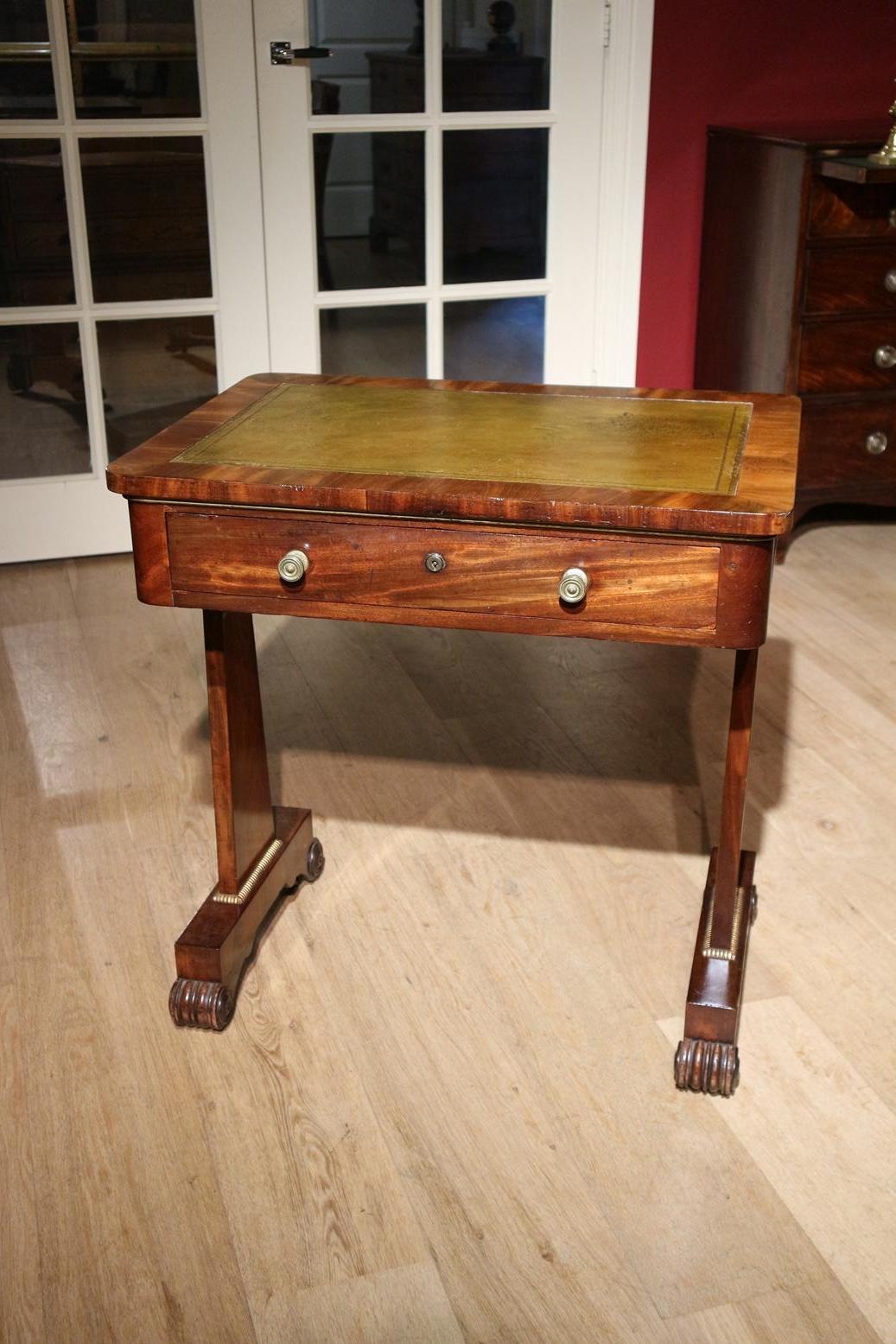 Beautiful small mahogany writing table and/or wall table. Top is provided with green leather. Table has 1 drawer. Other side is not a real drawer. The table can stand freely in the room. Beautiful warm weathered color mahogany. Table has a maker's