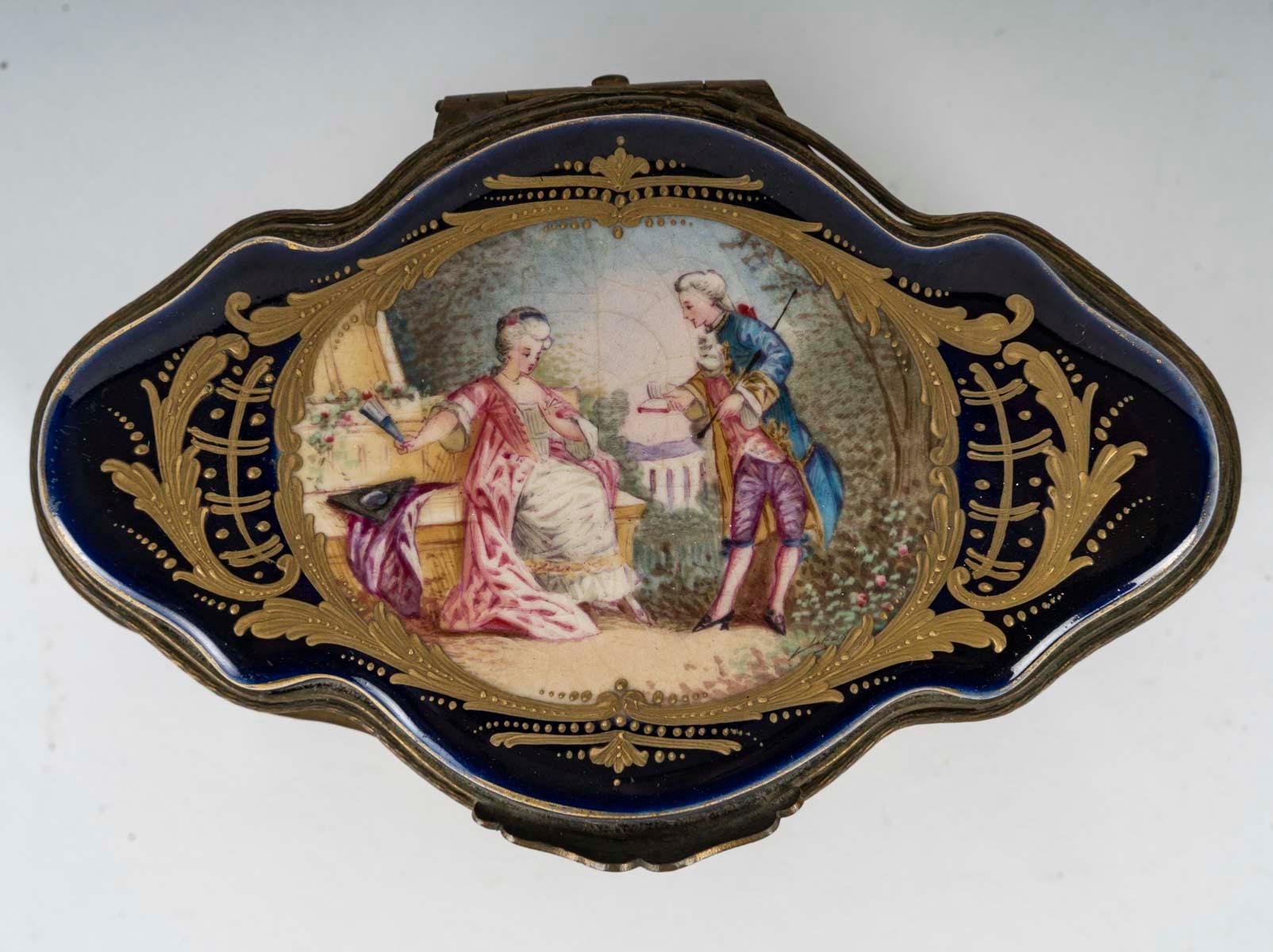 Small 19th century Napoleon III period Sèvres porcelain box.

A Napoleon III period small box, 19th century, in Sèvres blue porcelain, enamelled and gilded, with a gallant scene on the top.
H: 7cm, W: 14cm, D: 9.5cm