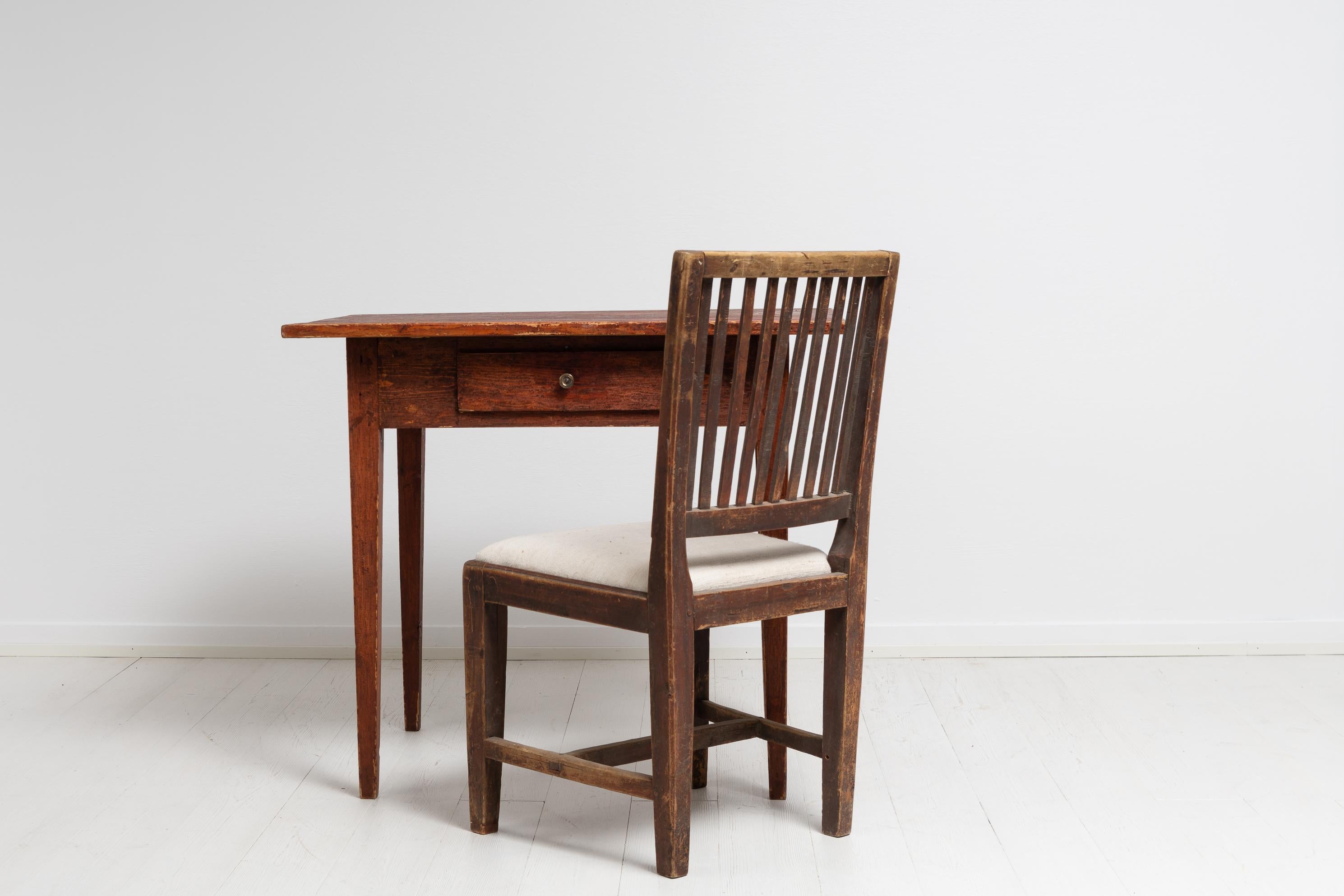 Folk art country house table in gustavian style from Northern Sweden. The table has a simple and solid construction with good proportions and a charming patina. The table is from around 1860 and made by hand in solid pine. Made with one large drawer