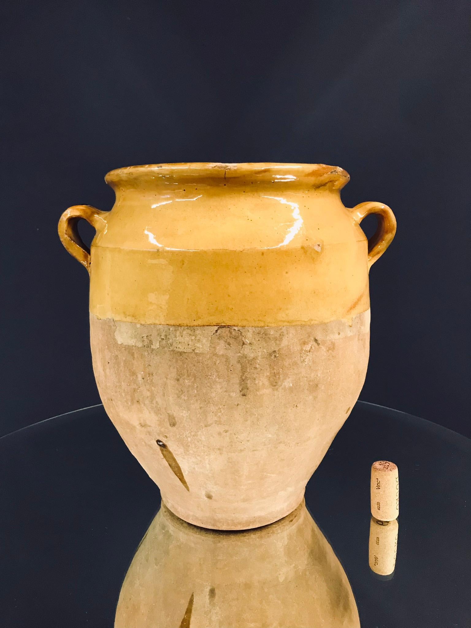 Beautiful small confit jar with its characteristic yellow glaze.
Confit jars were used primarily in the South of France for the preservation of meats such as duck or goose for dishes such as cassoulet or foie gras. The bottom halves were left