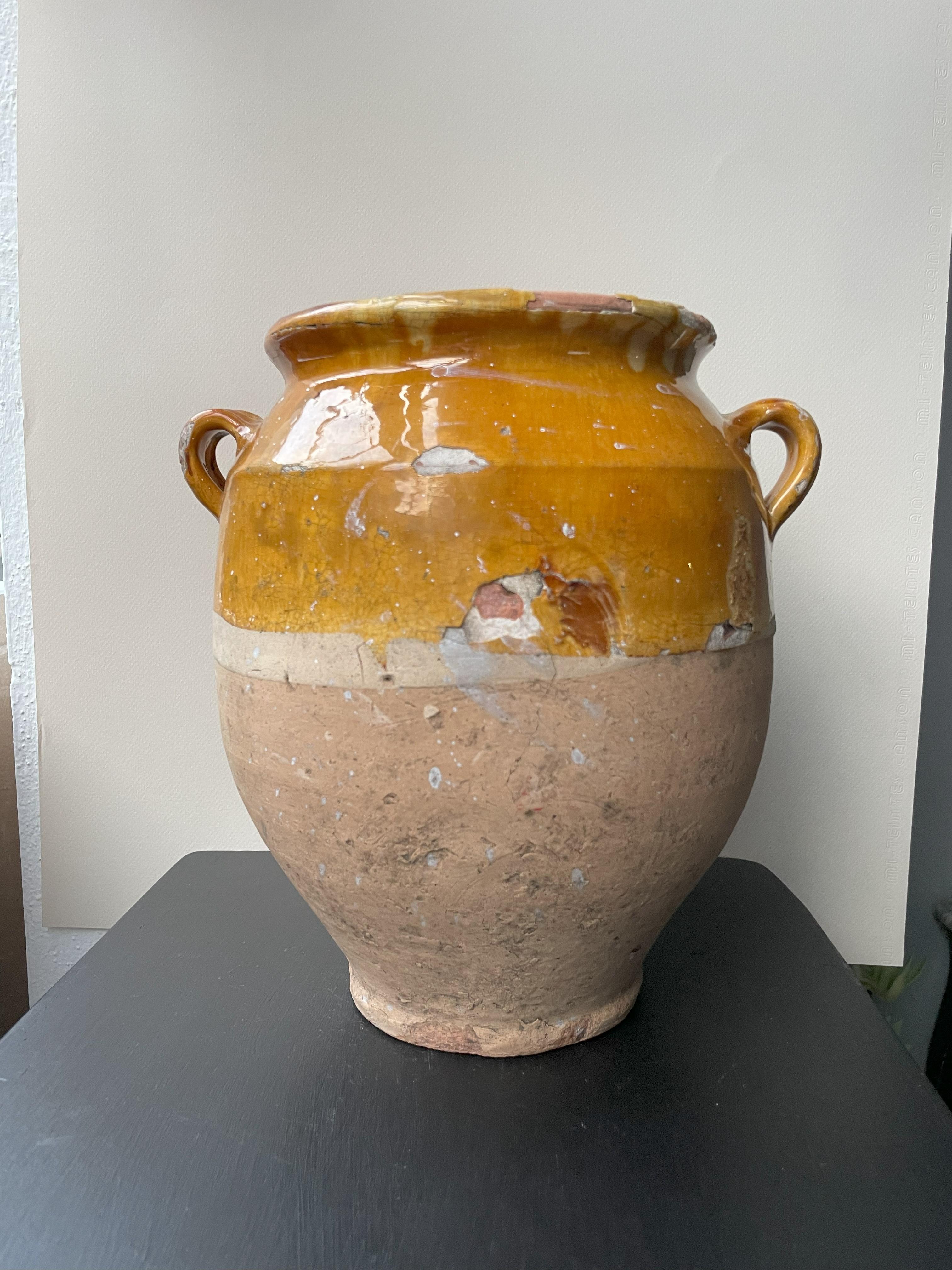 Beautiful small confit jar with its characteristic yellow glaze. Confit jars were used primarily in the South of France for the preservation of meats such as duck or goose for dishes such as cassoulet or foie gras. The bottom halves were left