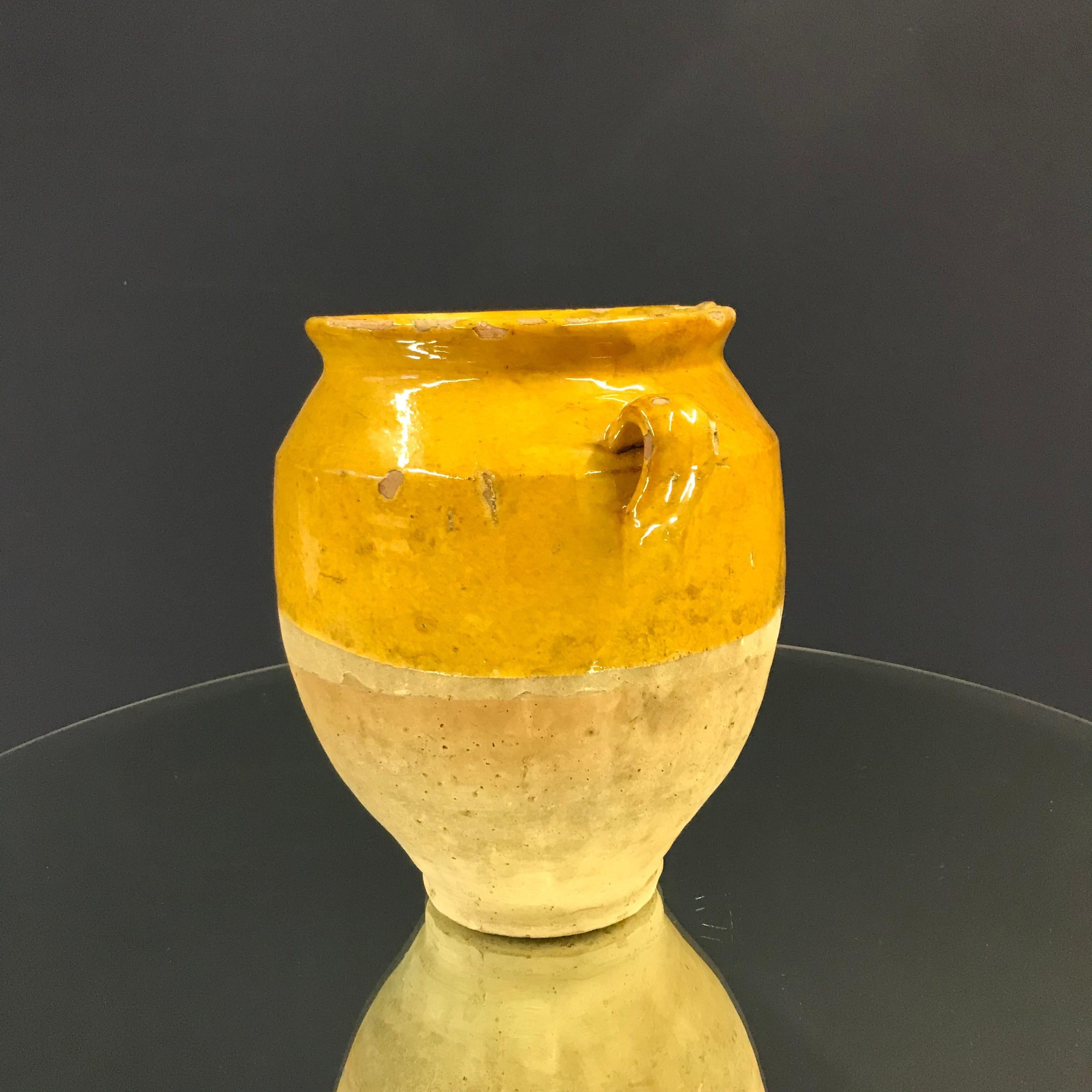 Beautiful small confit jar with its characteristic yellow glaze.
Confit jars were used primarily in the South of France for the preservation of meats such as duck or goose for dishes such as cassoulet or foie gras. The bottom halves were left
