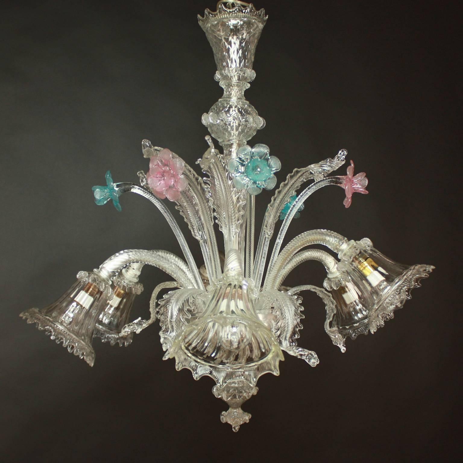 A small and elegant Murano six-light chandelier in transparent colors with sophisticated finishes in pink and light blue. With a centred bulbous column issuing branches and delicately cut Murano glass flowers and leaves. 

Ca'Rezzonico is the name