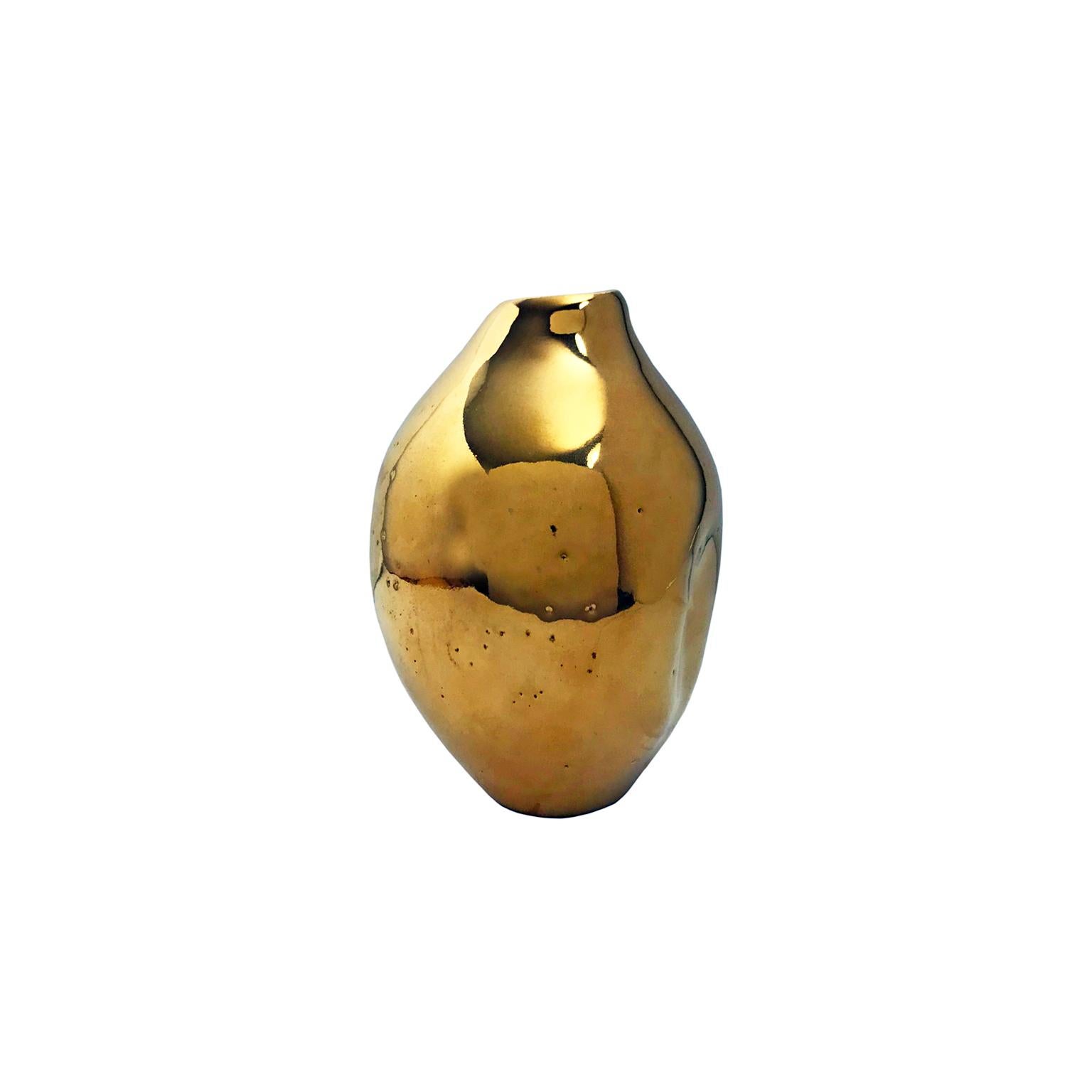 Small 22-karat gold lustre glaze ceramic vase #5 with double dent by Sandi Fellman, 2018. 

Veteran photographer Sandi Fellman's ceramic vessels are an exploration of a new medium. The forms, palettes, and sensuality of her photos can be found