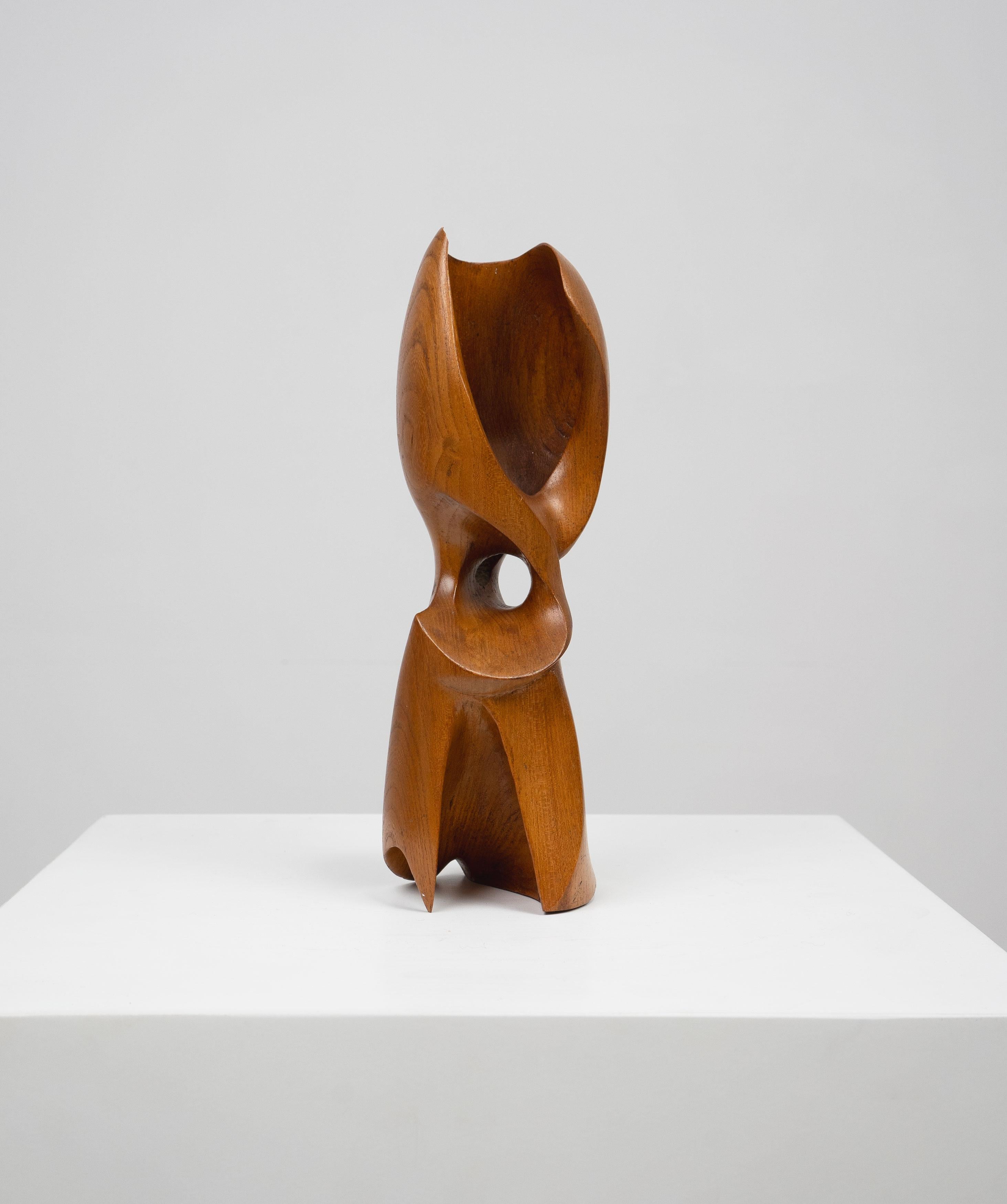 A mid 20th Century abstract sculpture in oak. 

Dimensions (cm, approx):
Height: 29
Diameter: 9
