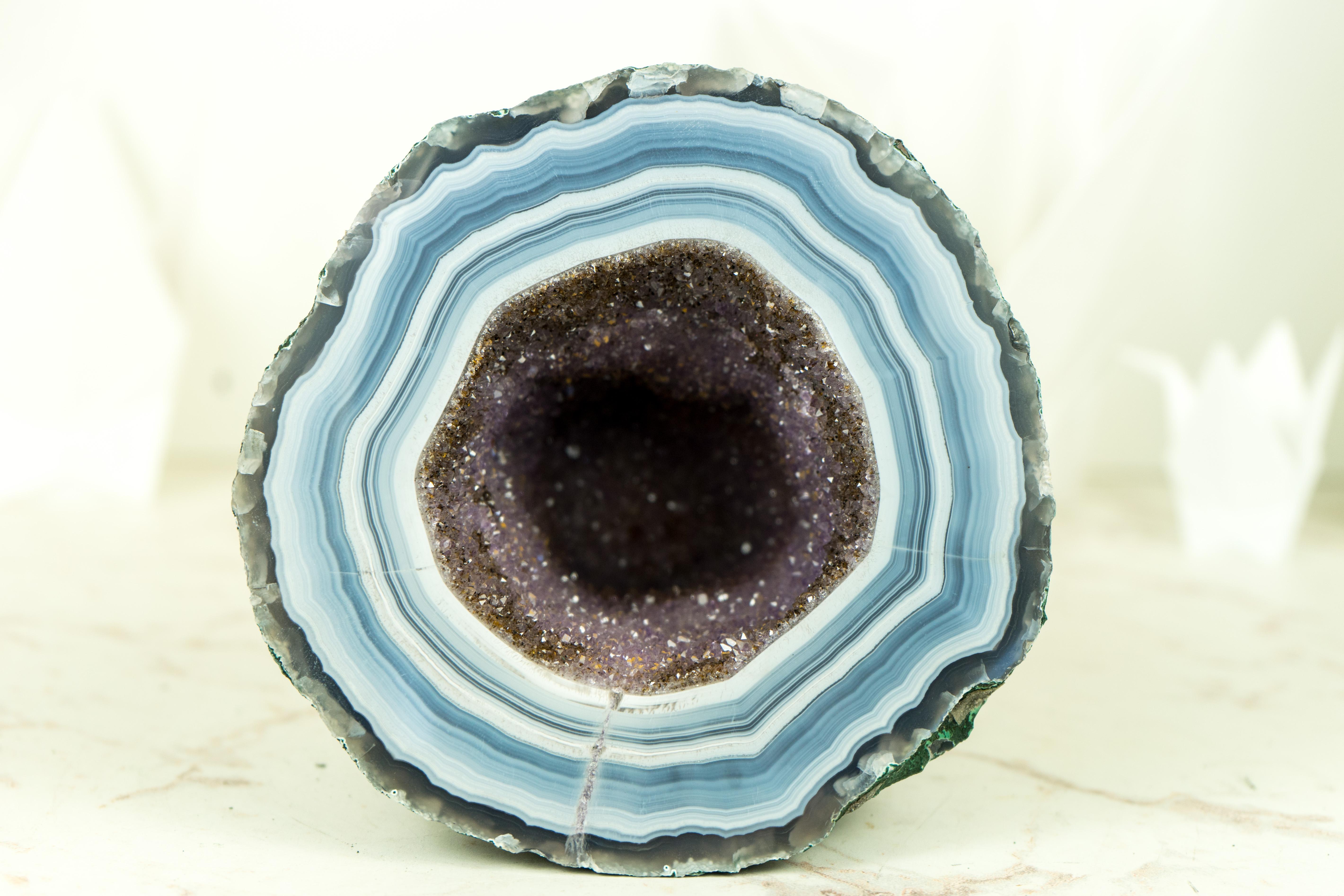 A small but Spectacular and attractive Amethyst with Agate Geode, this small beauty is filled with large, deep purple amethyst crystals with the rare Golden Goethite, making it a truly unique and valuable find. With its high-end, super extra