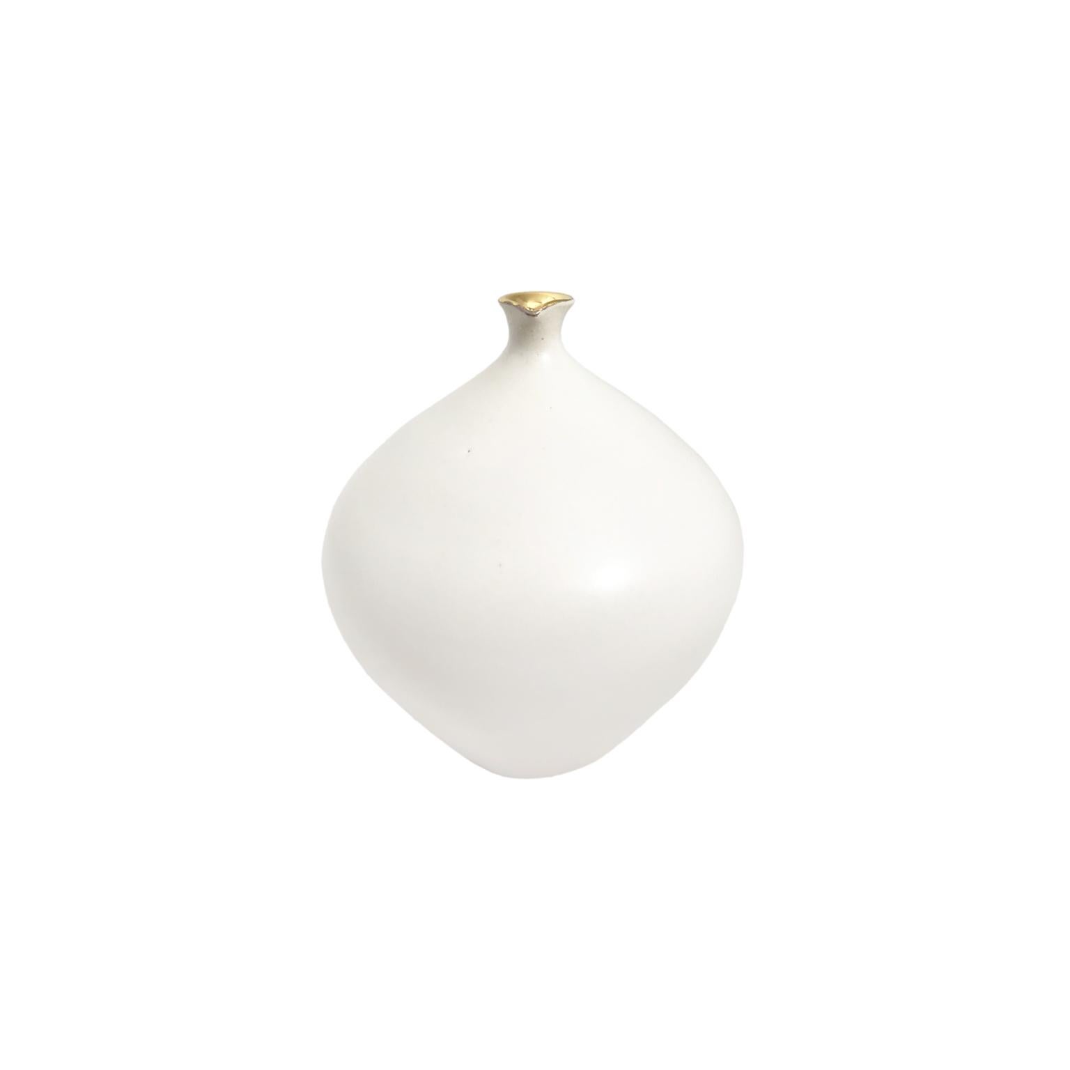 Small alabaster glaze ceramic bottle with 22k gold lustre spout lip by Sandi Fellman, 2018. 

Veteran photographer Sandi Fellman's ceramic vessels are an exploration of a new medium. The forms, palettes, and sensuality of her photos can be found