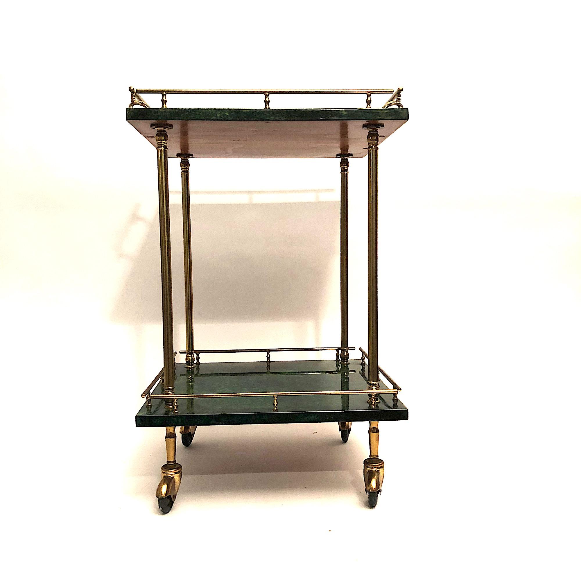 Aldo Tura 

Green goatskin parchment bar cart with two level. Nice Small Dimension. Nice vintage condition.

Aldo Tura started in the 1930s and fully developed in the 1950s a successful business designing pieces that were a mixture of sculptural