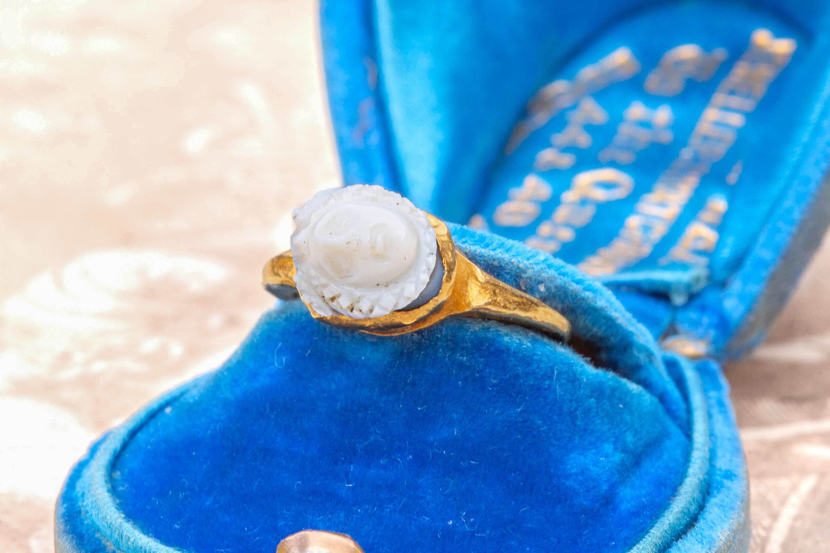 A scarce and small ancient Roman gold Medusa cameo ring, circa 2nd to 3rd century AD.

The carved layered onyx gemstone is white in colour and depicts the bust of Medusa engraved with crosshatched snakes for her hair. In Greek mythology, Medusa was