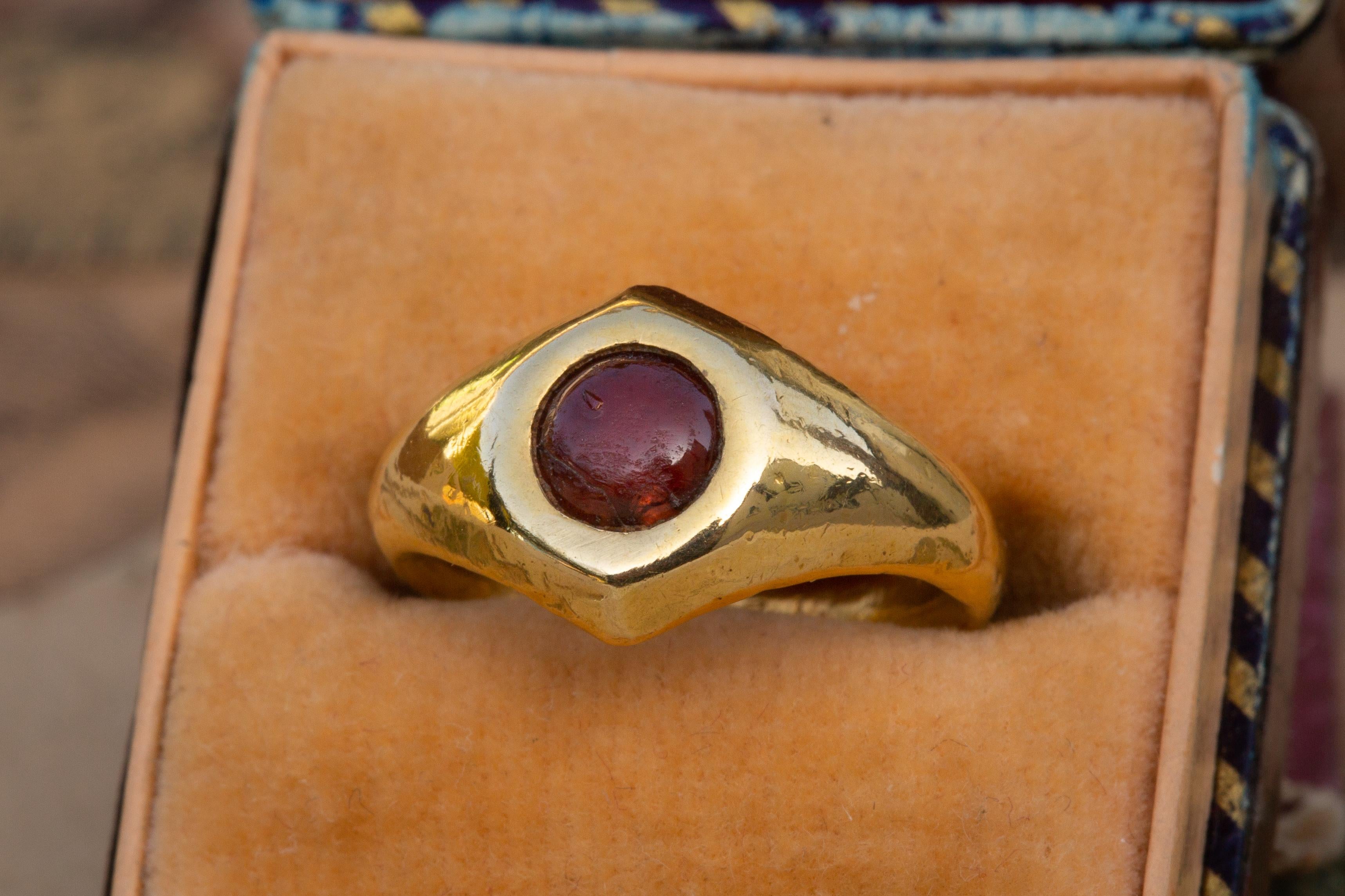Small Ancient Roman Period Gold Garnet Cabochon Ring

A beautiful example of a Roman garnet cabochon-set gold ring! It displays a Type 2b Roman Gaul finger-ring shape (Guiraud classification) which dates the ring to between the 1st century BCE and