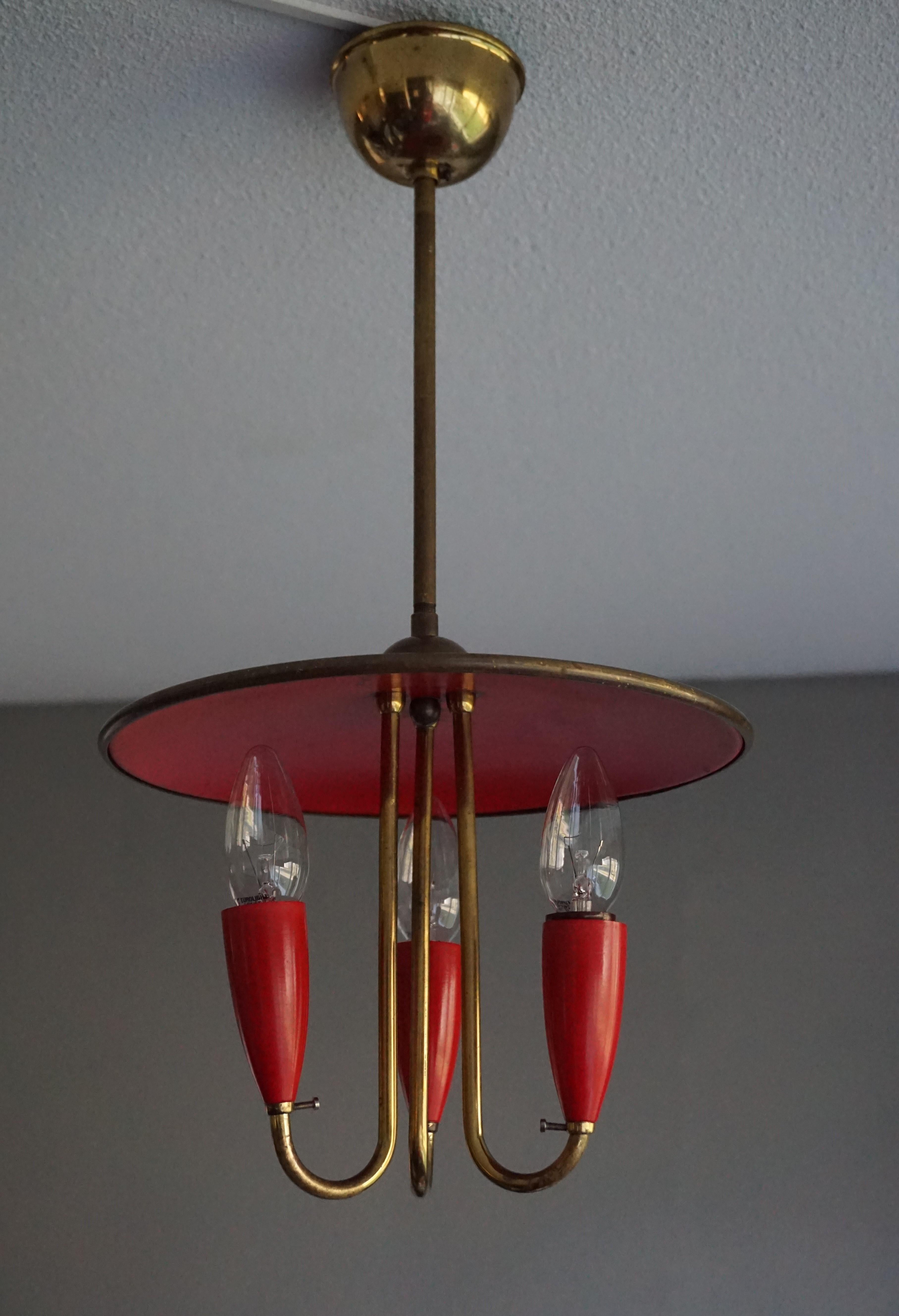 Rare 1960s 3 light pendant. 

For the mid-century enthousiast we also have this striking little light fixture. Its modernist design and complementing materials and colors makes this rare chandelier a real joy to own and look at. There is some wear