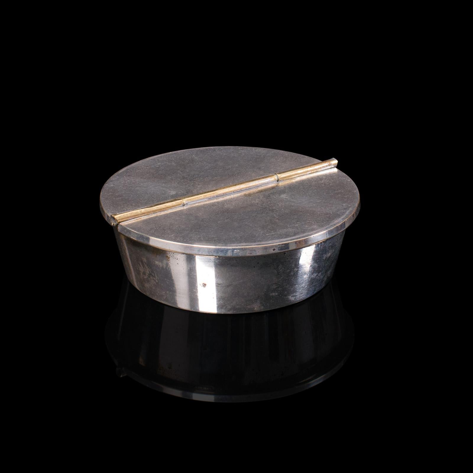 This is a small antique ash tray. An English, cast white metal lidded cigarette rest or cufflink pot, dating to the Edwardian period, circa 1910.

Charmingly petite with pleasing finish
Displays a desirable aged patina throughout
Bright
