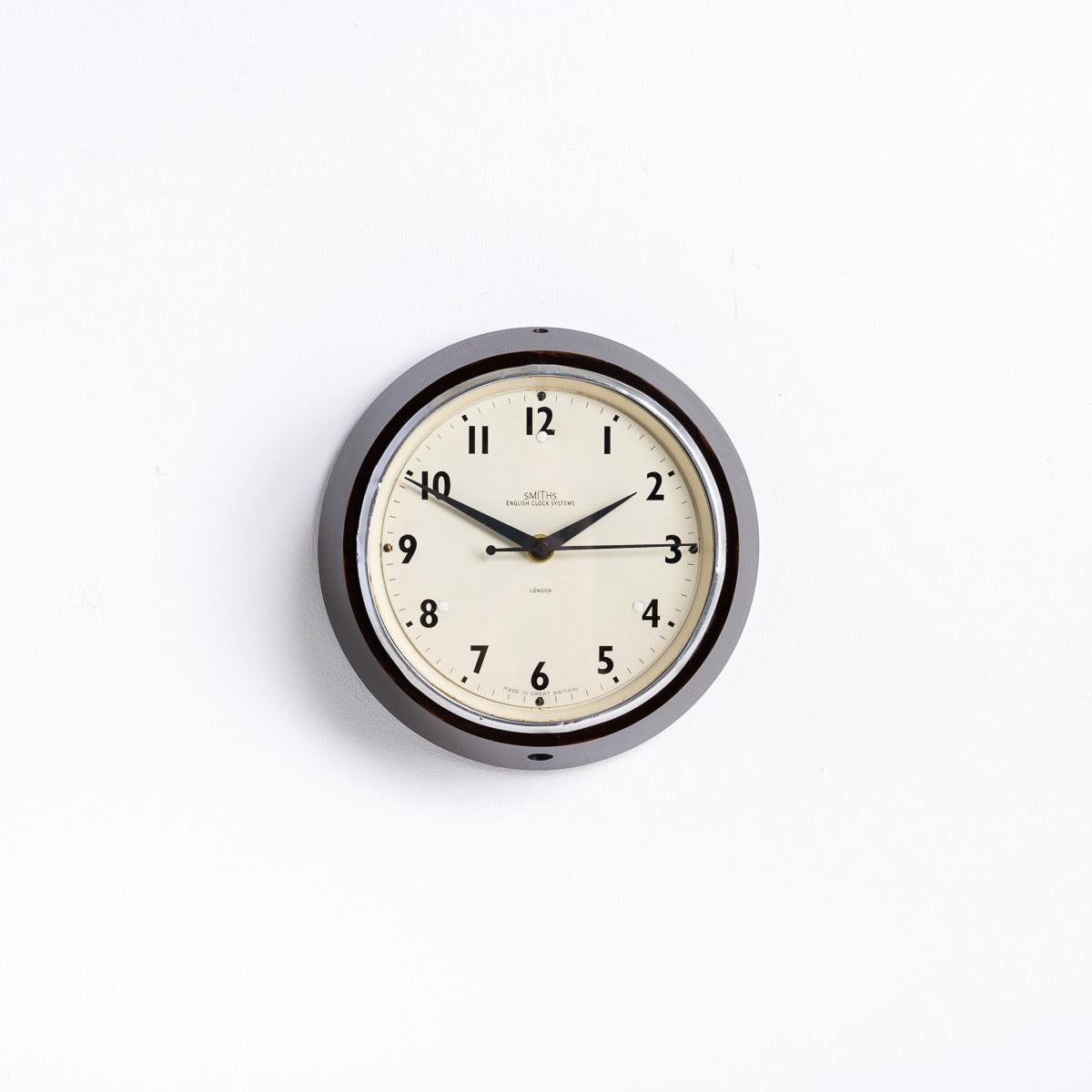 SMALL VINTAGE FACTORY WALL CLOCK BY SMITHS

A stunning find from a Brick Factory in Wales, upon conversion to living accommodation a bricked up store was discovered where 12 clocks were found. Of those 12, nine were identical Smiths English Clock