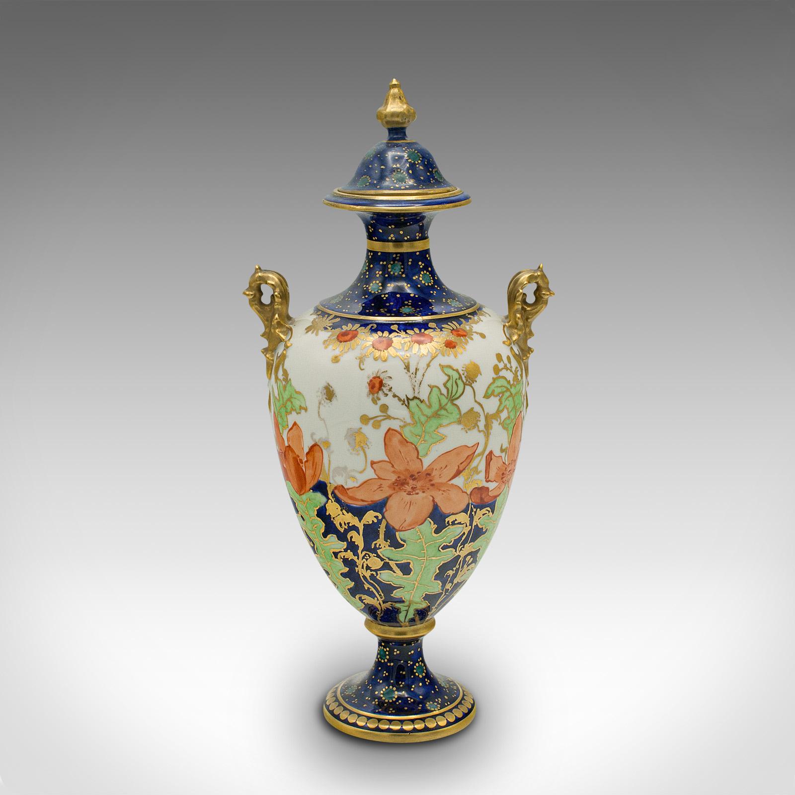 This is a small antique baluster urn. An English, ceramic decorative posy vase by Royal Crown Derby, dating to the late Victorian period, circa 1900.

Of petite form, graced with delightful colour and finish
Displays a desirable aged patina and