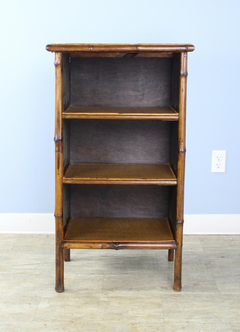 Small Antique Bamboo Bookcase with Pressed Leather Sides at 1stDibs