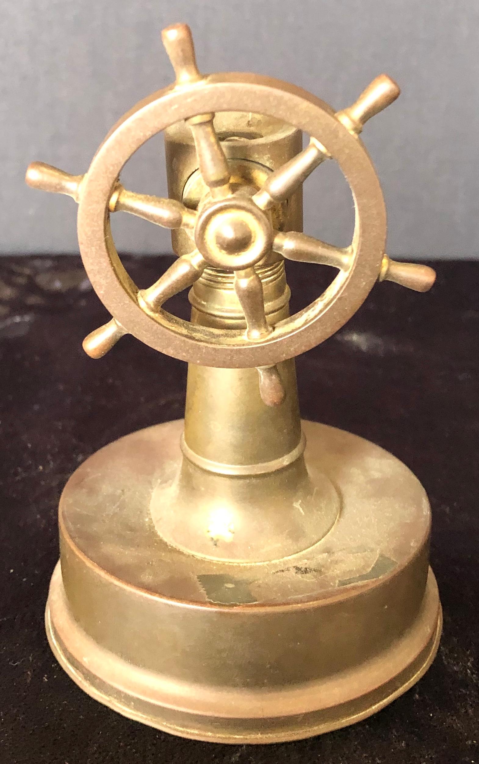 Small antique brass ships wheel tabletop cigar cutter circa 1920. Hinged base cover opens for disposing the cigar tips.
This is part of the personal collection purchased directly, From the estate of Jerry Terranova, Author of 