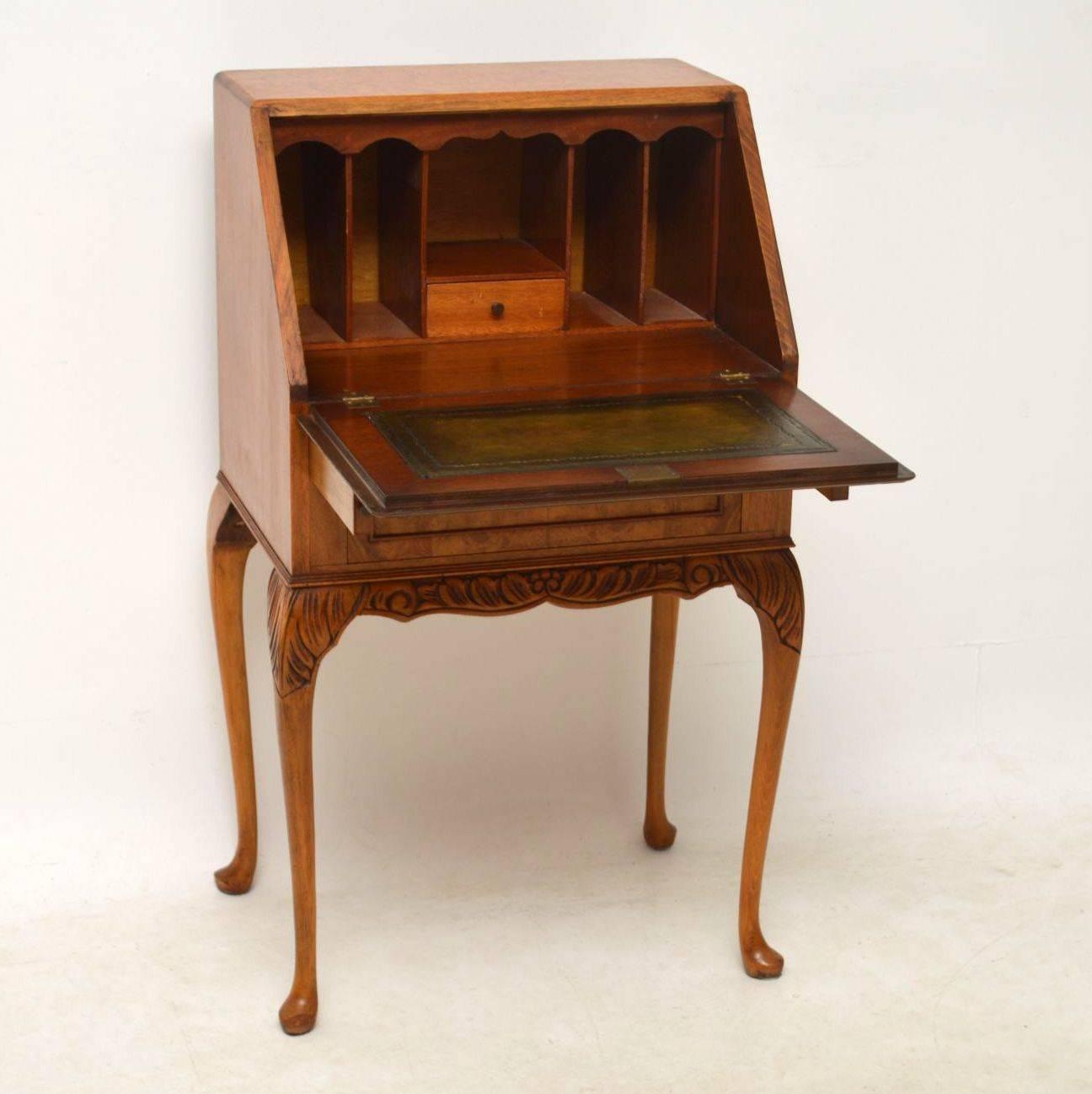 Small antique burr maple and walnut bureau in good condition, dating to circa 1930s period. It has two manual loafers which support the drop down flap. Inside, is a tooled leather writing surface, plus pigeon holes and one small drawer. This bureau