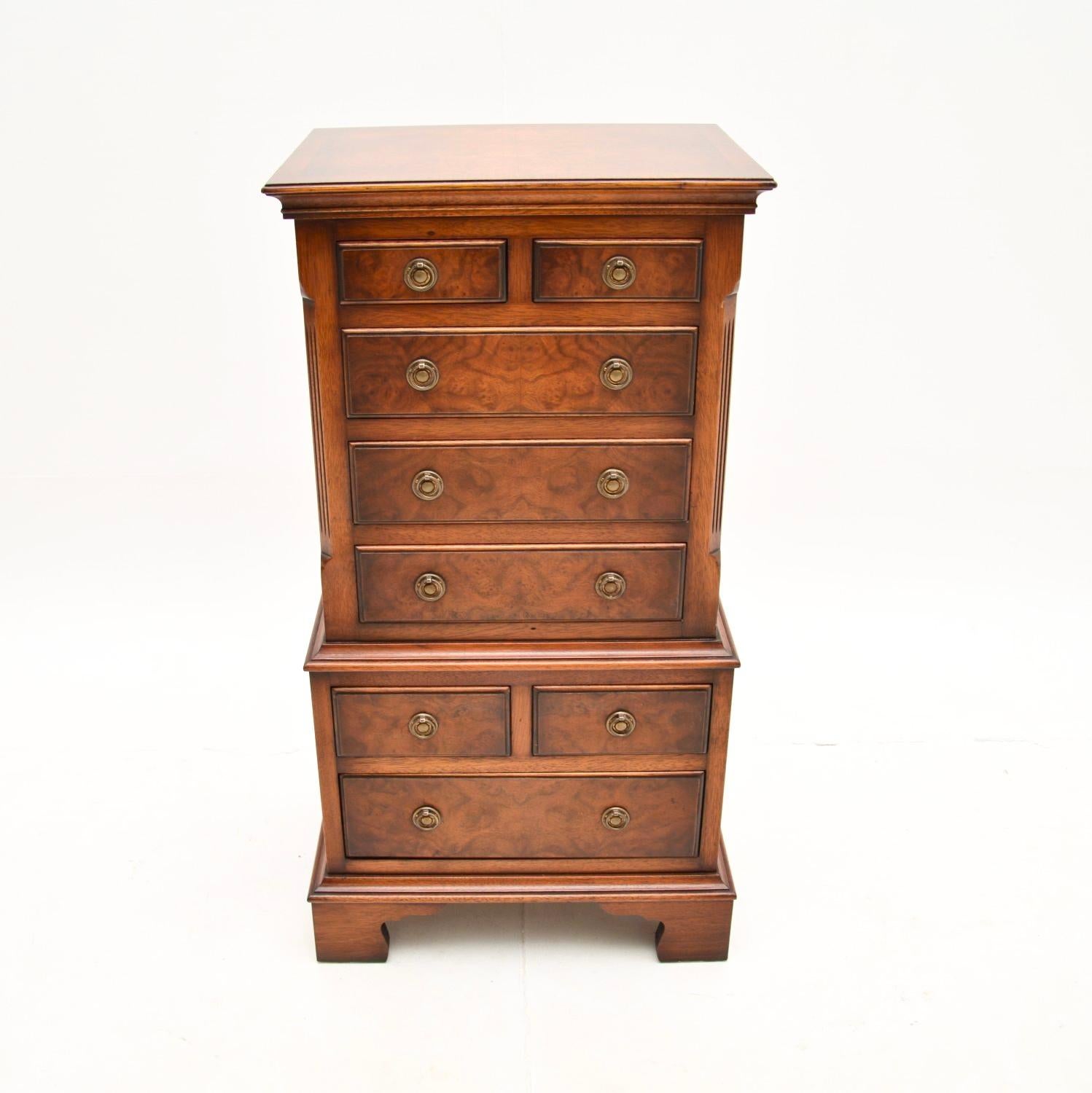 A smart and useful small antique burr walnut chest of drawers. It is in the Georgian style, this was made in England and dates from around the 1950’s.

It is of superb quality, this is full of many small drawers and this model is often known as a