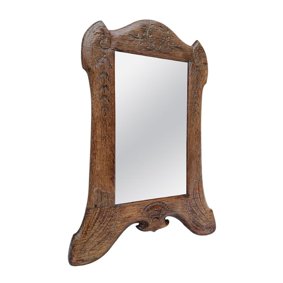 Small french antique wall mirror, Art Deco shape in carved wood engraved with foliages decoration, circa 1930 (Antique frame width: 3.5 cm / 1.37 in.). Modern glass mirror. Antique wood back.
