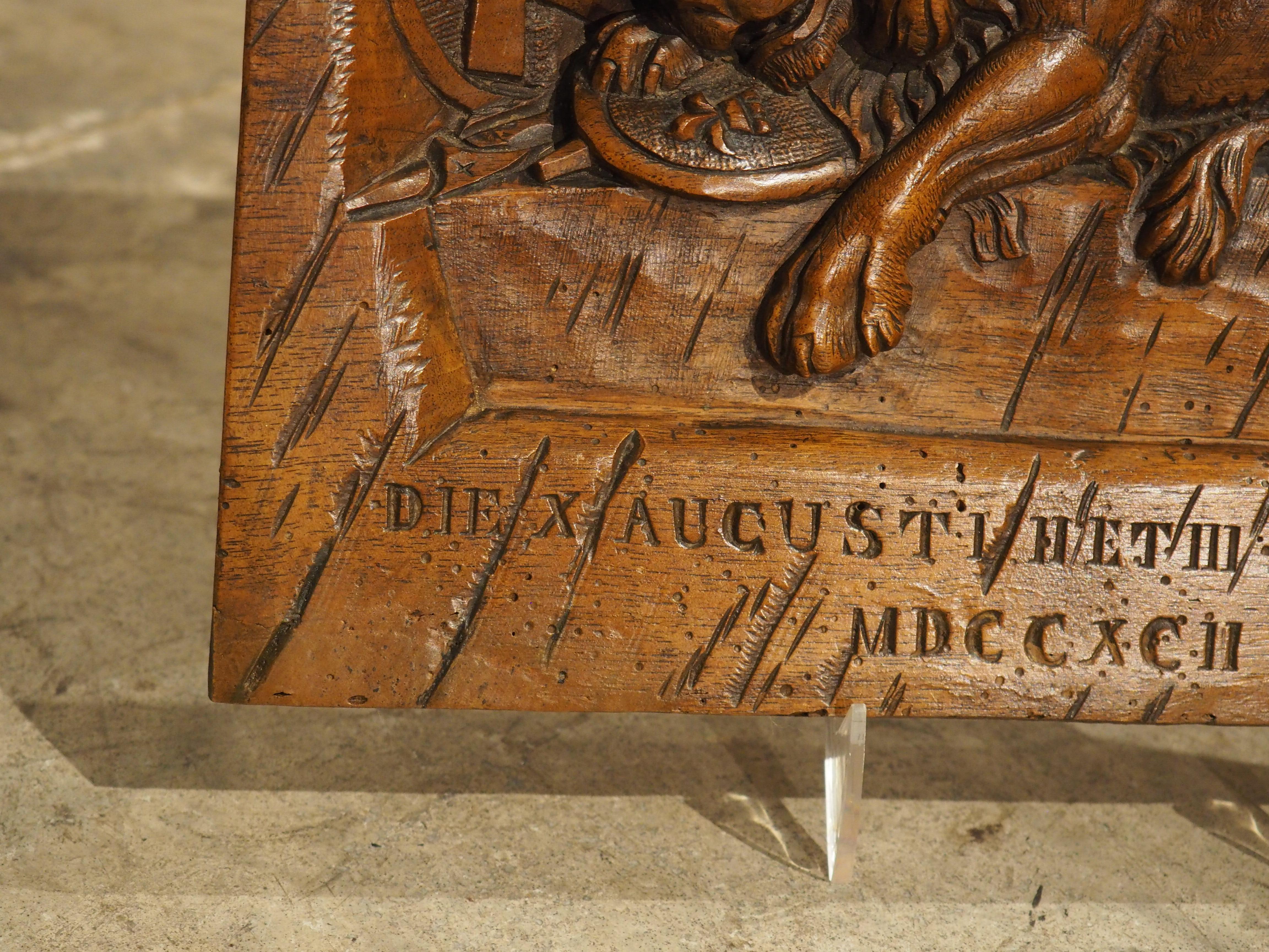A wonderful rendition of the famed Lion of Lucerne, this small plaque from the late 1800s was hand-carved in walnut. The wood has a rich brown patina that has been accentuated by French wax, allowing the nuances of the carvings to come out. Above